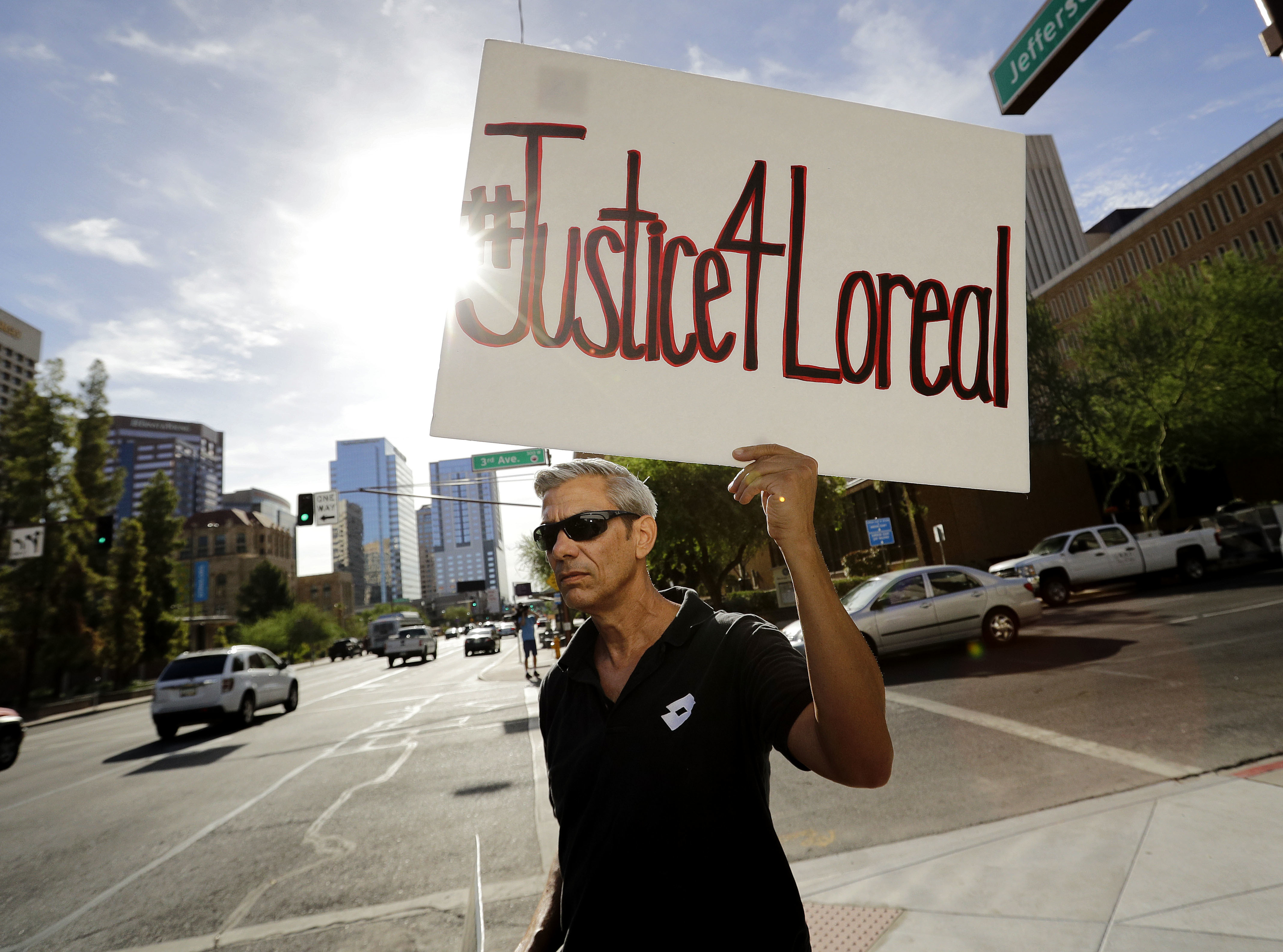 Chris Fleischman protests outside Maricopa County Attorney Bill Montgomery's office in Phoenix, July 25, 2016. Loreal Tsingine was a Navajo woman who was fatally shot by an Arizona police officer.