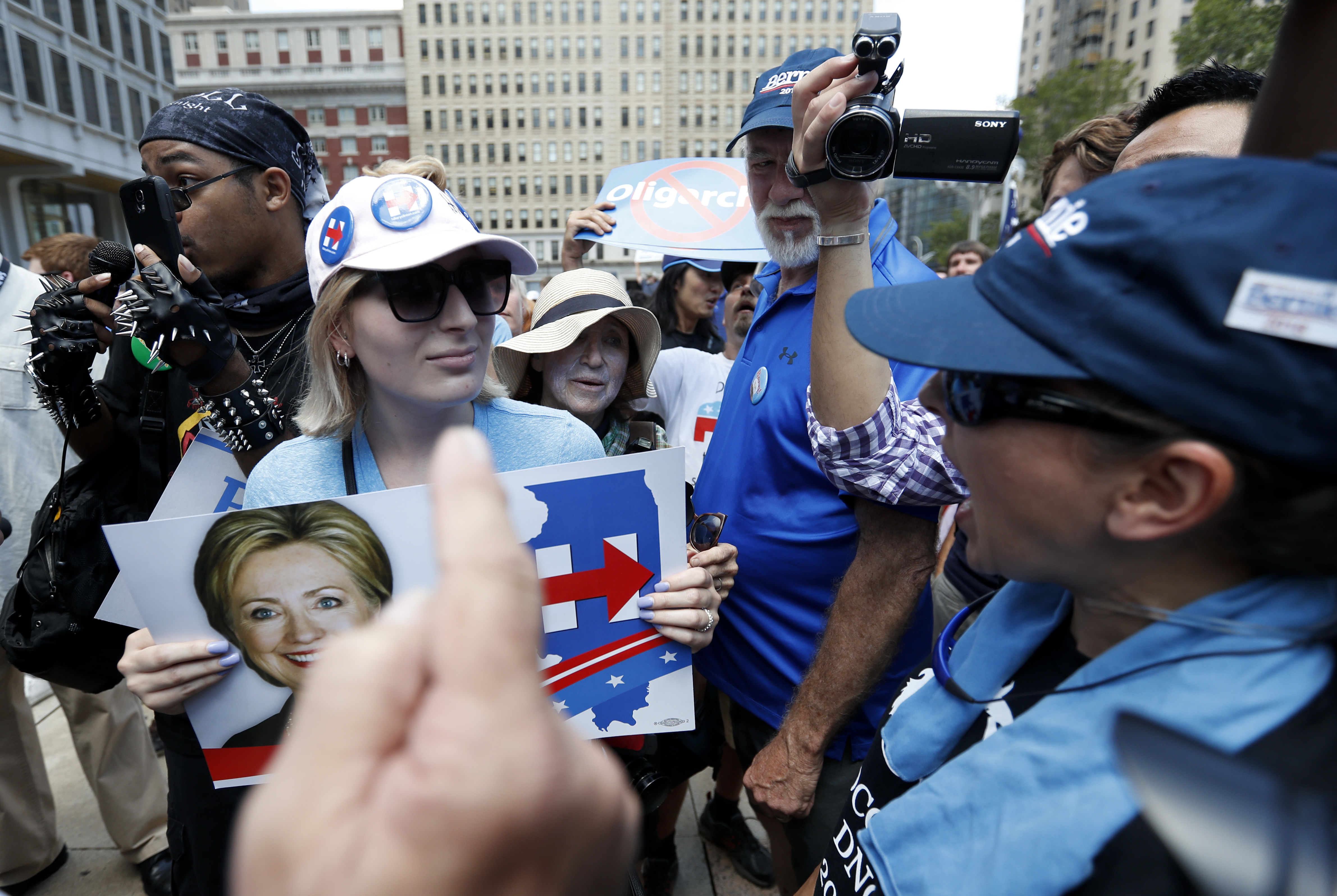 The Latest: 2 men argue over flag at flag-burning protest