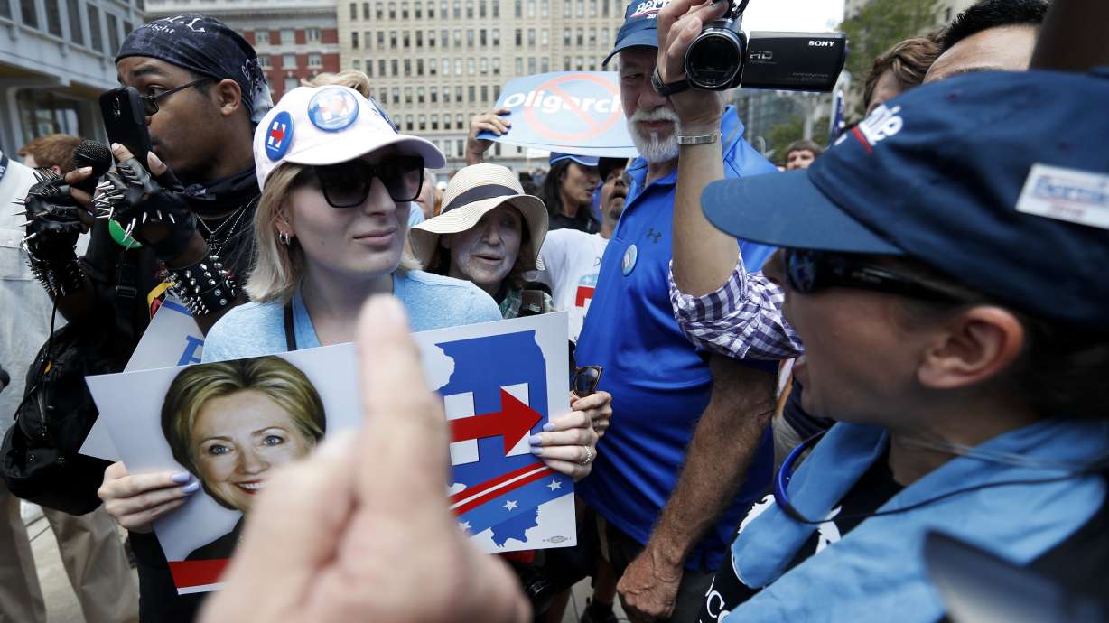 The Latest: 2 men argue over flag at flag-burning protest
