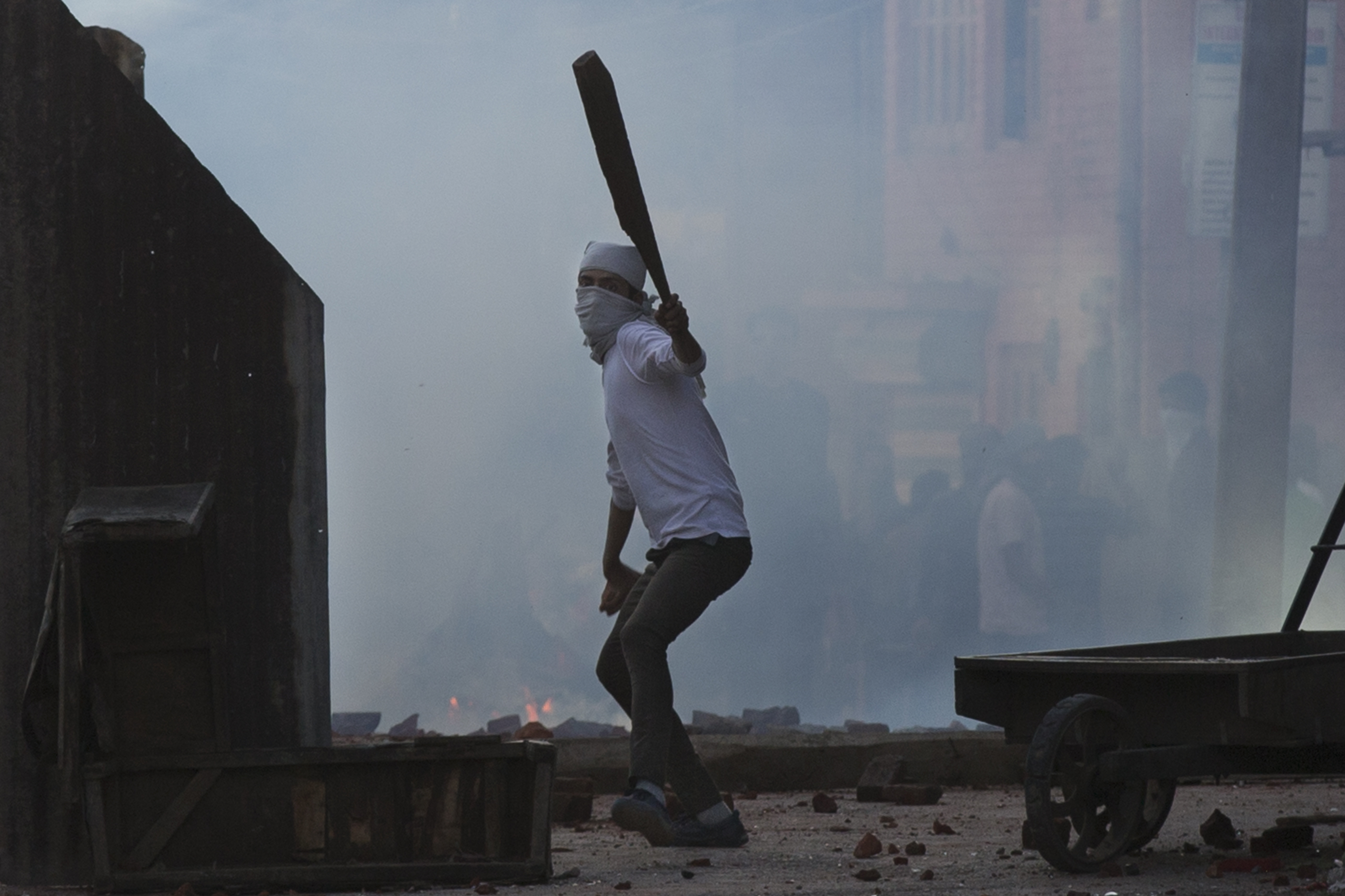 India re-imposes curfew in Kashmir city, but clashes persist