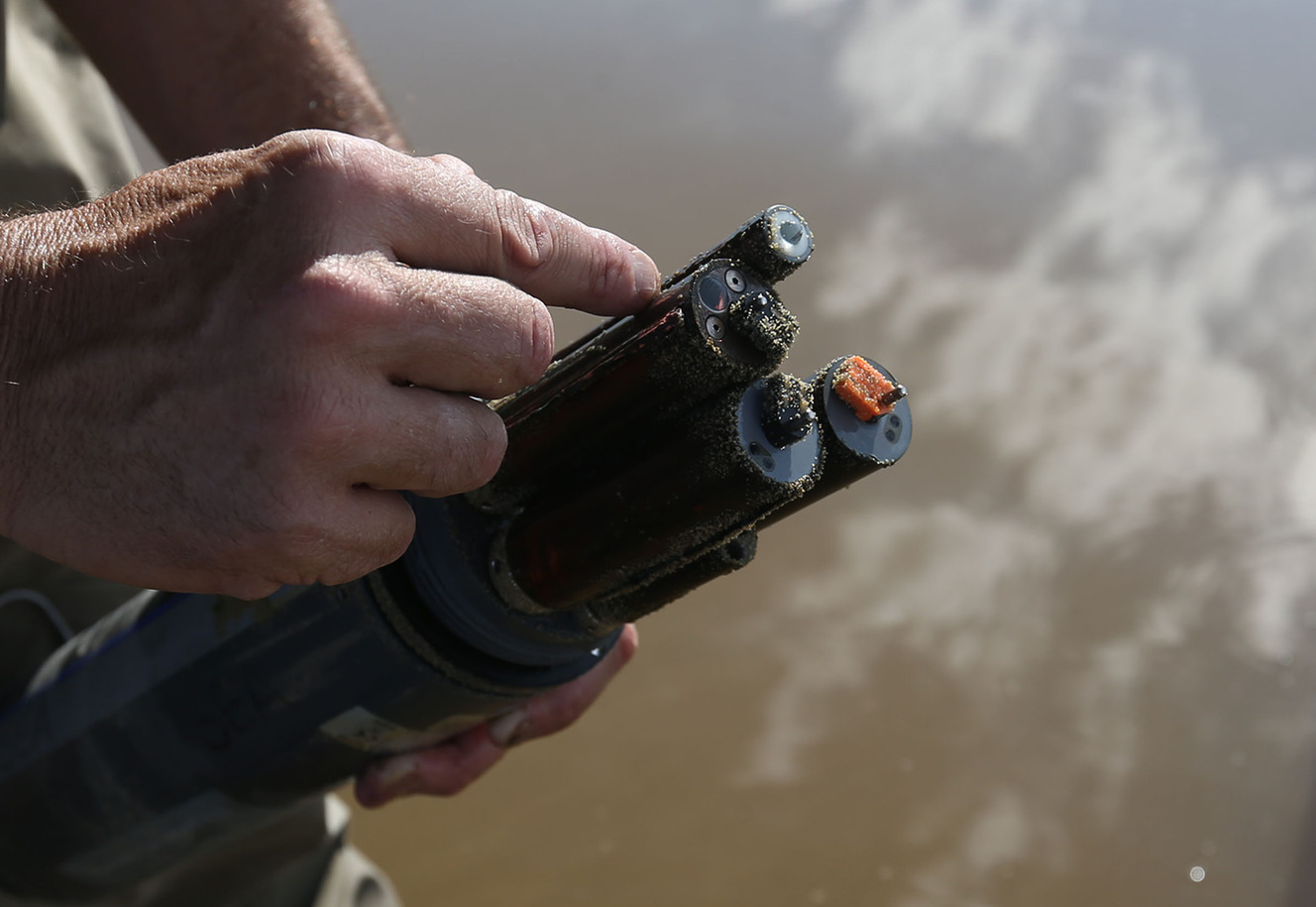 Environmental scientist Marshall Baillie of the Department of Environmental Quality's Division of Water Quality for the State of Utah collects data from a sonde in Farmington Bay on Friday, July 29, 2016. Data collected from the sonde will be used to interpret the water quality in Farmington Bay. (Photo: Laura Seitz, Deseret News)