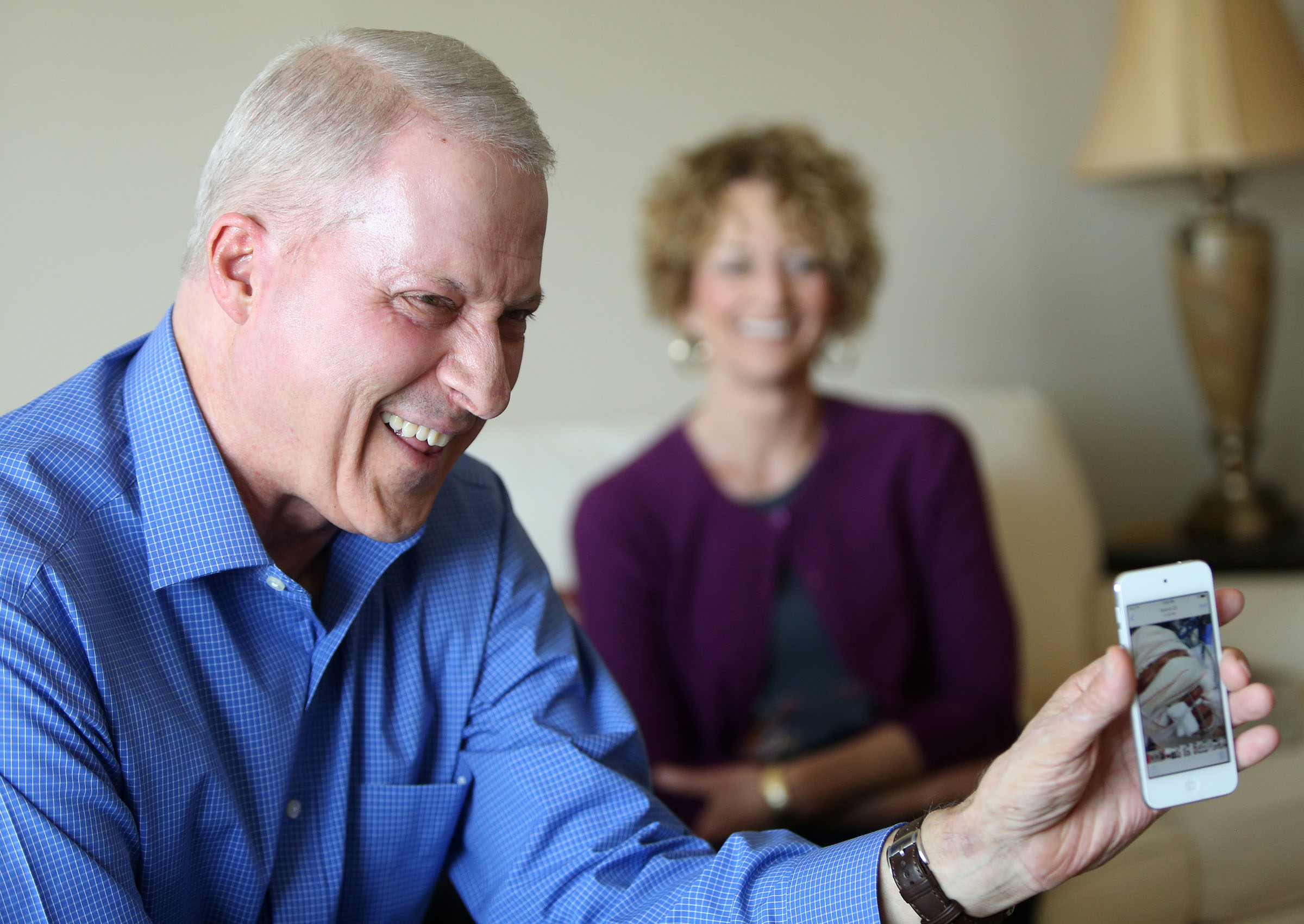 Richard Norby laughs at an unrecognizeable photo of himself from his time in the hospital recovering from the March terrorist attack on the Brussels airport at home in Salt Lake City on Wednesday, July 27, 2016. Norby was in Brussels serving a mission for the Church of Jesus Christ of Latter Day Saints. (Photo: Kristin Murphy, Deseret News)