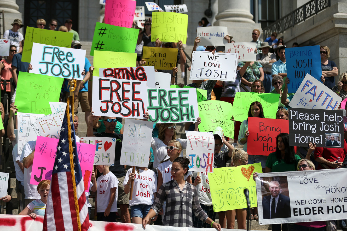 People hold signs calling for the freeing of Josh Holt at the Capitol in Salt Lake City on Saturday, July 30, 2016. Family members and supporters held a rally to call for the release of Josh Holt, who has been jailed in Venezuela. (Photo: Spenser Heaps, Deseret News)