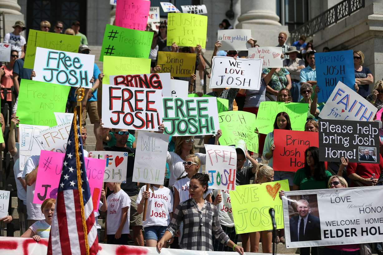 People hold signs calling for the freeing of Josh Holt at the Capitol in Salt Lake City on Saturday, July 30, 2016. Family members and supporters held a rally to call for the release of Josh Holt, who has been jailed in Venezuela. (Photo: Spenser Heaps, Deseret News)
