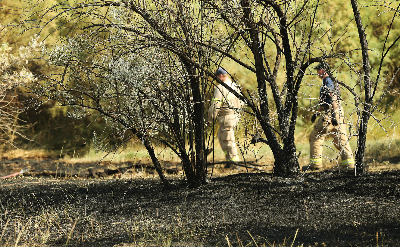 Firefighters work on a grass fire on the Jordan River Parkway Trail near the Oxbow Jail in Salt Lake City on Sunday, July 31, 2016. (Photo: Jeffrey D. Allred, Deseret News)