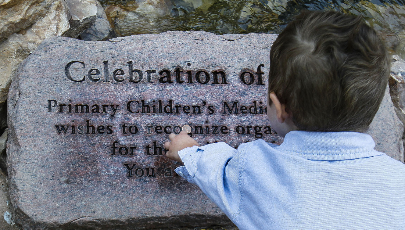 Dash Johnson, 4, a patient at Primary Children’s Hospital, and his sister drop a penny on a new plaque during the reopening of the Angel Garden at the hospital in Salt Lake City on Monday, Aug. 1, 2016. The redesigned garden includes more than 1,000 new plants and trees, as well as legacy monuments, including the Butterfly Angel statue, a commissioned 5-foot bronze. Dash's family spearheaded renewal project. (Photo: Weston Kenney, Deseret News)