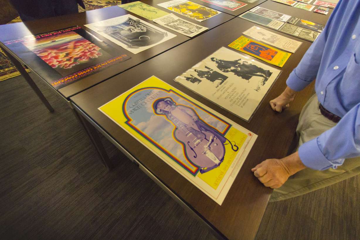 Ron Bitton, curator of historical maps and newspapers for the Marriott Library, takes a look at posters from the 1960s and 1970s, including one from a local venue promoting the Grateful Dead. (Photo: Carter Williams, KSL.com)