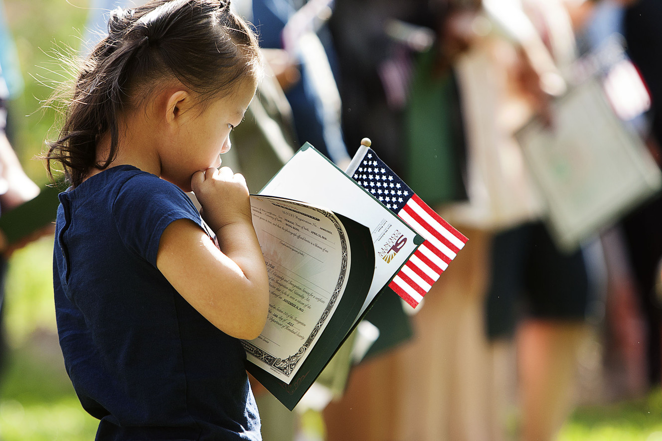 Naomi Flitton, 6, looks at her U.S. citizenship certificate at Wheeler Historic Farm in Murray, Friday, Aug. 5, 2016. U.S. Citizenship and Immigration Services presented citizenship certificates to 23 children, ages 6 to 17, during a Friday's special ceremony. (Photo: Hans Koepsell, Deseret News)