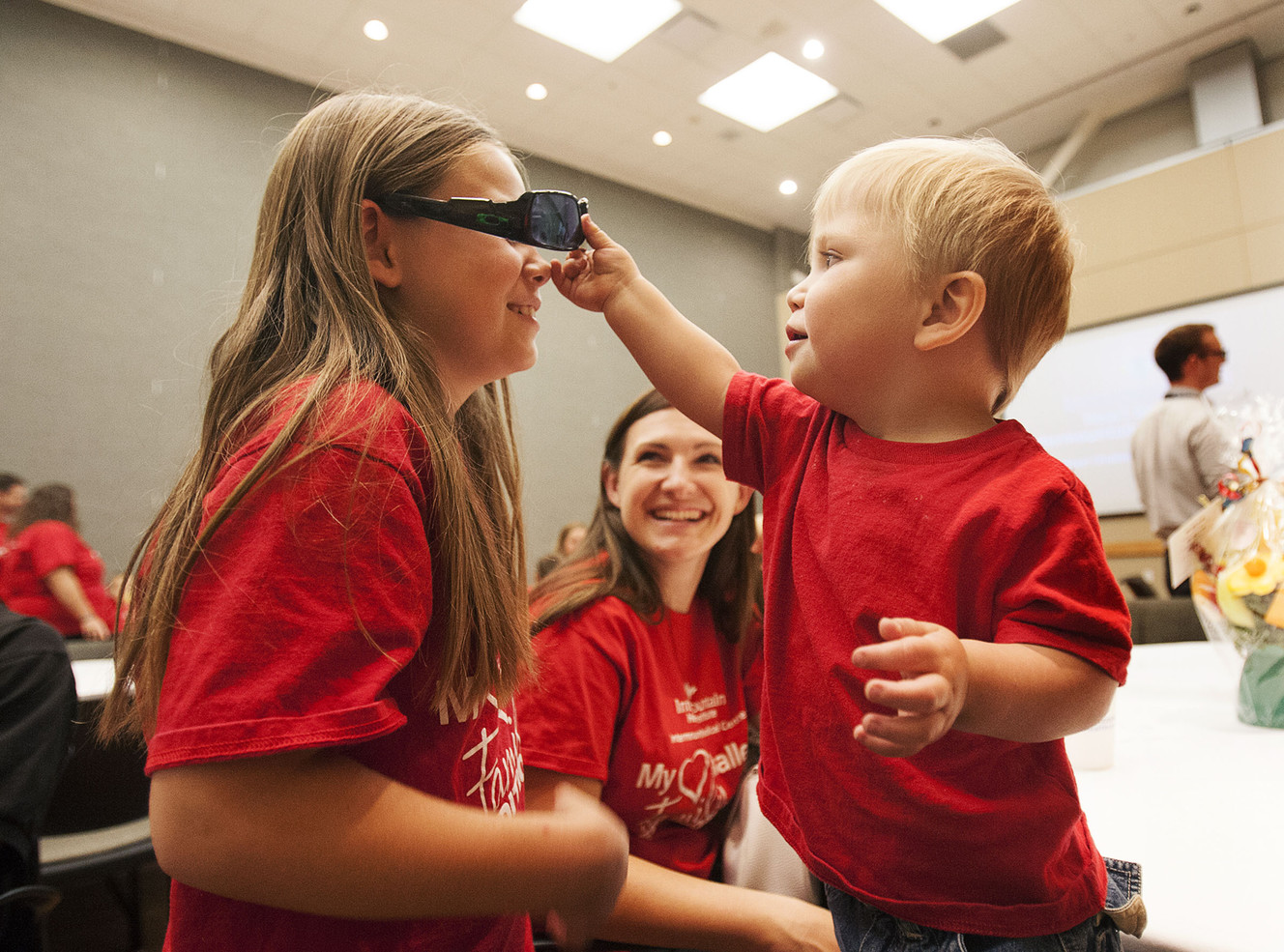 Kylee Pitcher, 9, smiles as she plays with her brother, Corbin, 2, at the My Heart Challenge award banquet at Intermountain Medical Center in Murray on Friday, Aug. 5, 2016. The Pitcher family won the challenge. (Photo: Hans Koepsell, Deseret News)