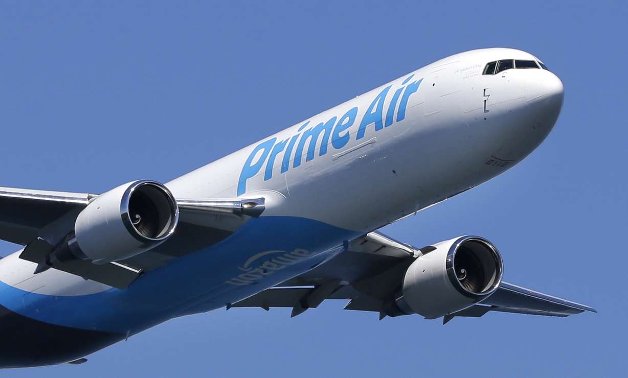 A Boeing 767 with an Amazon.com "Prime Air" livery flies over Lake Washington, Friday, Aug. 5, 2016, as part of the Boeing Seafair Air Show. Amazon unveiled its first branded cargo plane Thursday, one of 40 freighters that will make up the company's own air transportation network of 40 Boeing jets leased from Atlas Air and Air Transportation Services Group, which will operate the air cargo network. (AP Photo/Ted S. Warren)