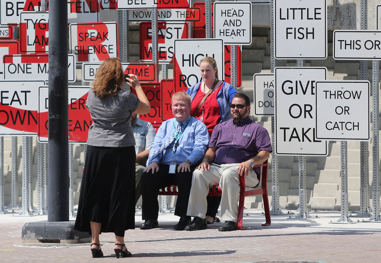 Jennifer Evans takes a photo of Thomas Riley, Mariah Hill and Bob Spohr in front of Point of View, the new art installation in front of the Salt Palace Convention Center in Salt Lake City on Thursday, Aug. 4, 2016. (Photo: Kristin Murphy, Deseret News)