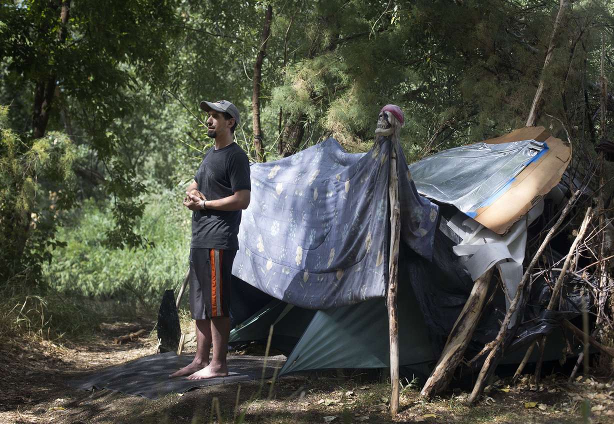 Jaren Corral has been living in a tent beside the Jordan River for more than two years. Recovering from a surgery has prevented him from getting back to work as a construction worker. He views his time living by the river as temporary until he is healed and able to return to work. He said watching the drug overdoses and living with bedbugs for three months at the homeless shelter almost killed him. Photograph taken in West Valley City on Wednesday, Aug. 10, 2016. (Photo: Laura Seitz, Deseret News)