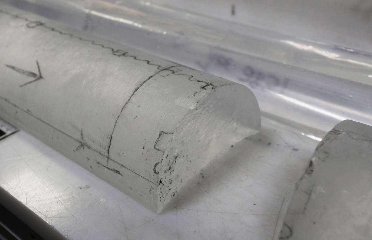 This Aug. 8, 2016 photo shows an arctic ice core on a table inside the deep freeze work area at the lab, in Lakewood, Colo. A solar flare or other cosmic events can leave distinctive radioactive atoms on the snow. Dust blown in from distant continents offers clues about atmospheric circulation. (AP Photo/Brennan Linsley)