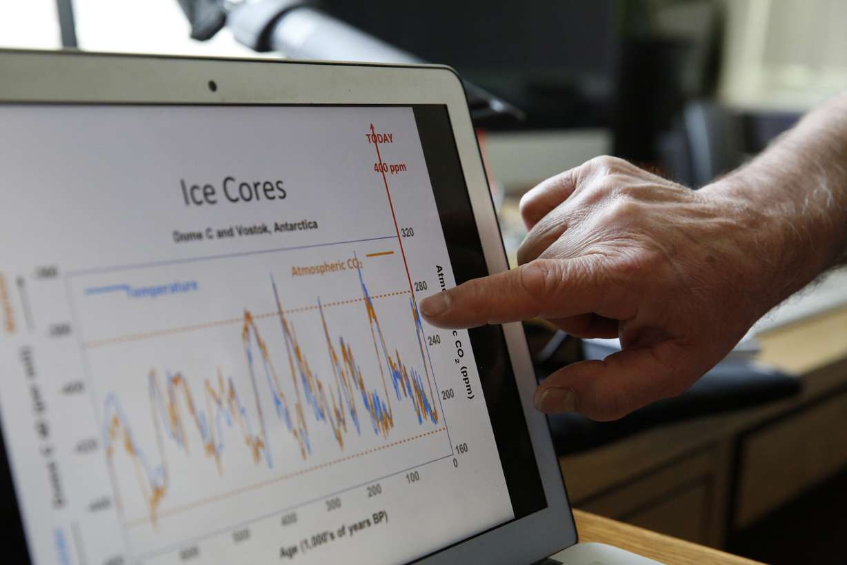 In this June 3, 2016 photo, Bruce Vaughn, who manages the INSTAAR Stable Isotope lab, refers to his laptop while discussing his data collection and analysis for climate change research, at the University of Colorado, in Boulder, Colo. Vaughn, who is one of many researchers who relies on ice core data, says of the ice cores: "It's as if we're standing on the ice sheet writing down the temperature for the last 800,000 years. It's that good." (AP Photo/Brennan Linsley)