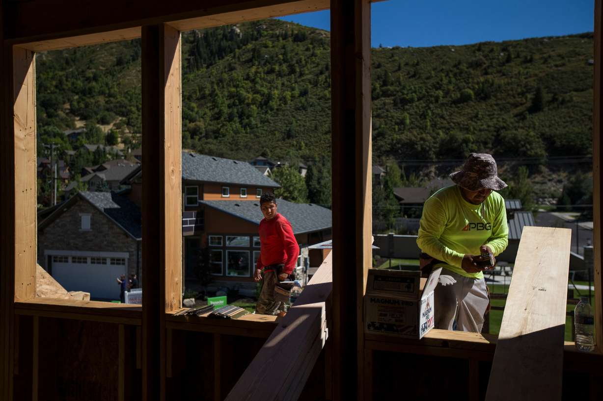 Martin Fragoso Villegas, left, and Raul Peres, right, work on building a zero energy ready home in the Treseder at Little Cottonwood development in Sandy on Friday, Aug. 12, 2016. (Photo: Spenser Heaps, Deseret News)