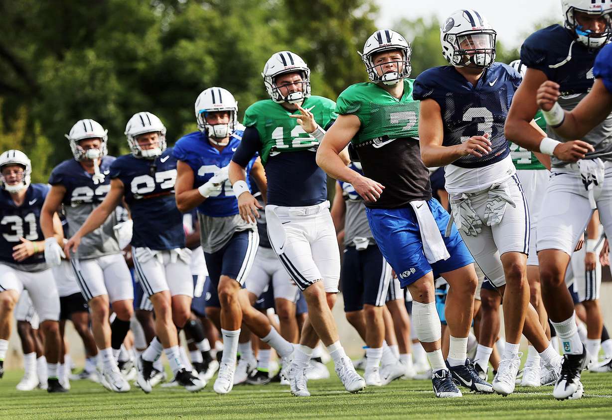Taysom Hill, right center, and Tanner Mangum, behind him, workout during practice with the Brigham Young University football team in Provo on Monday, Aug. 15, 2016. (Photo: Ravell Call, Deseret News)