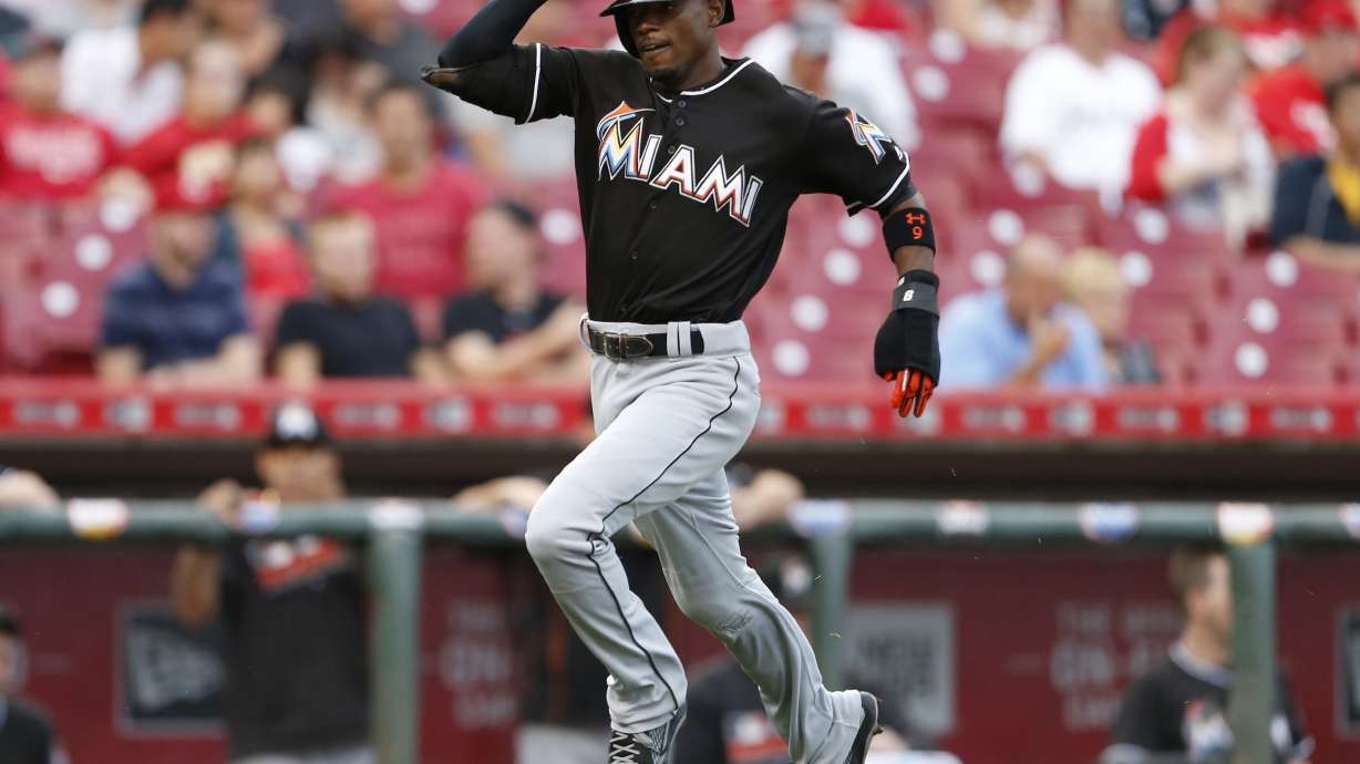 Johnson leads Marlins to 6-3 win over Reds