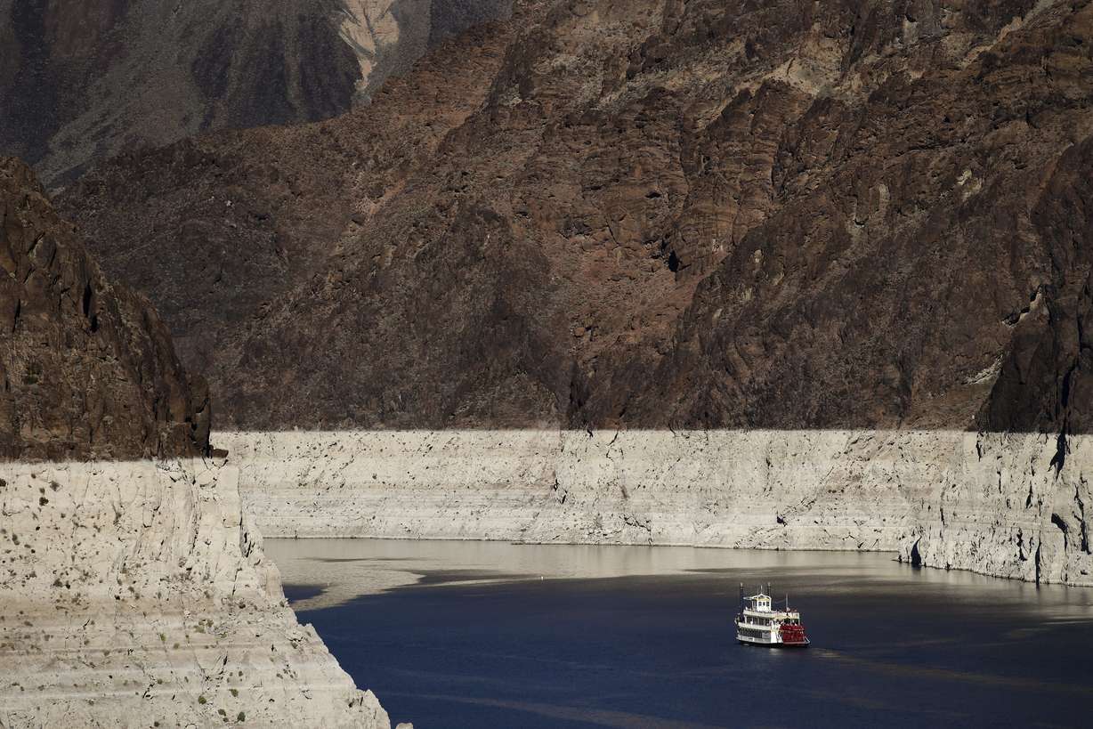 FILE--In this Oct. 14, 2015, file photo, a riverboat glides through Lake Mead on the Colorado River at Hoover Dam near Boulder City, Nev. Amid an historic drought in the West, federal water managers are due to release an annual projection of surface levels at Lake Mead that'll determine whether water deliveries from the crucial Colorado River reservoir will be cut next year to Arizona, Nevada and California. (AP Photo/Jae C. Hong, file)