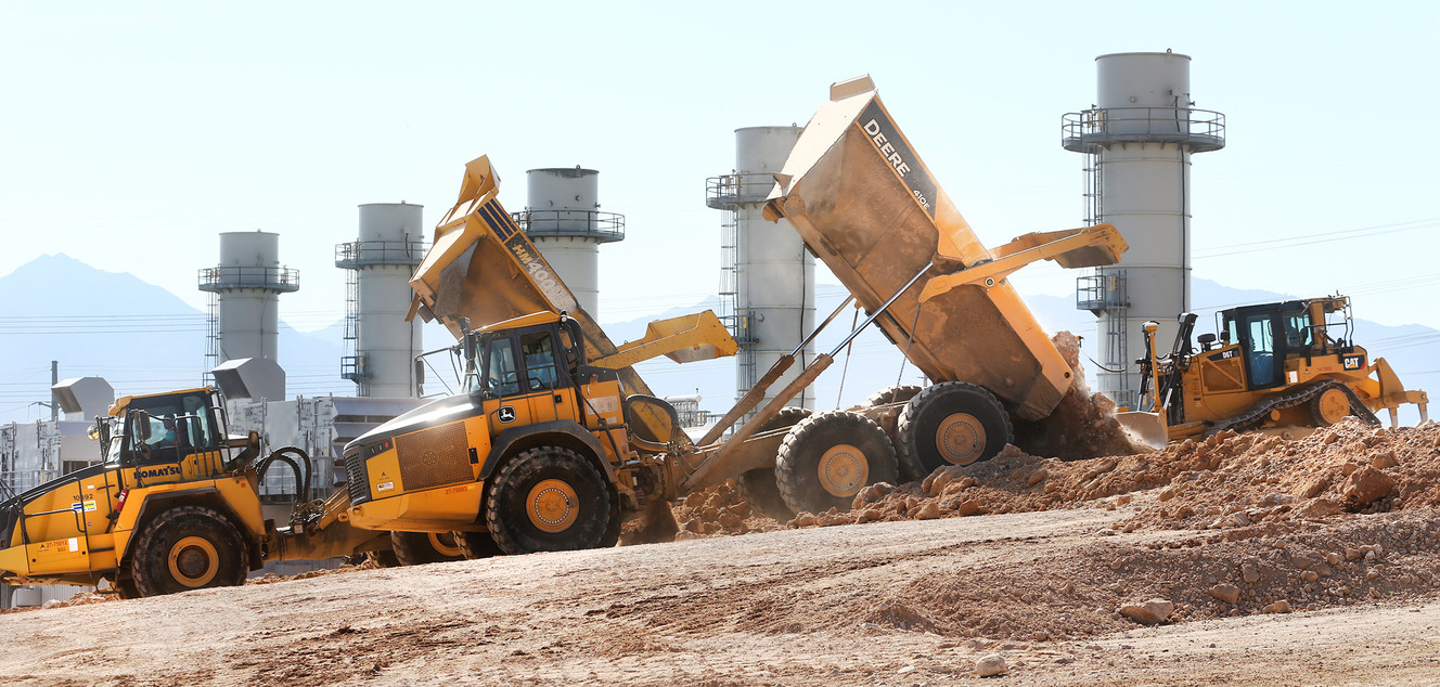 Haul trucks dump embankment material on the road surface near the USANA Amphitheater as the Utah Department of Transportation issued an important safety reminder to the public ahead of the school year to "Think Safety" in and around the Mountain View Corridor construction zone on Tuesday, Aug. 16, 2016. (Photo: Scott G Winterton, Deseret News)