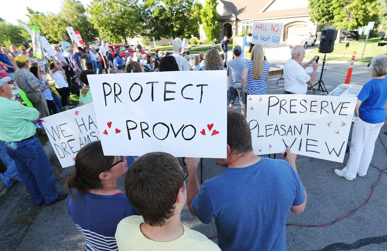 Residents of the Pleasant View neighborhood hold signs while rallying to preserve their legacy single-family neighborhood in Provo on Thursday, June 16, 2016. David Hall and his NewVista Foundation are trying to turn the area into a corporate social experiment. (Photo: Jeffrey D. Allred, Deseret News)