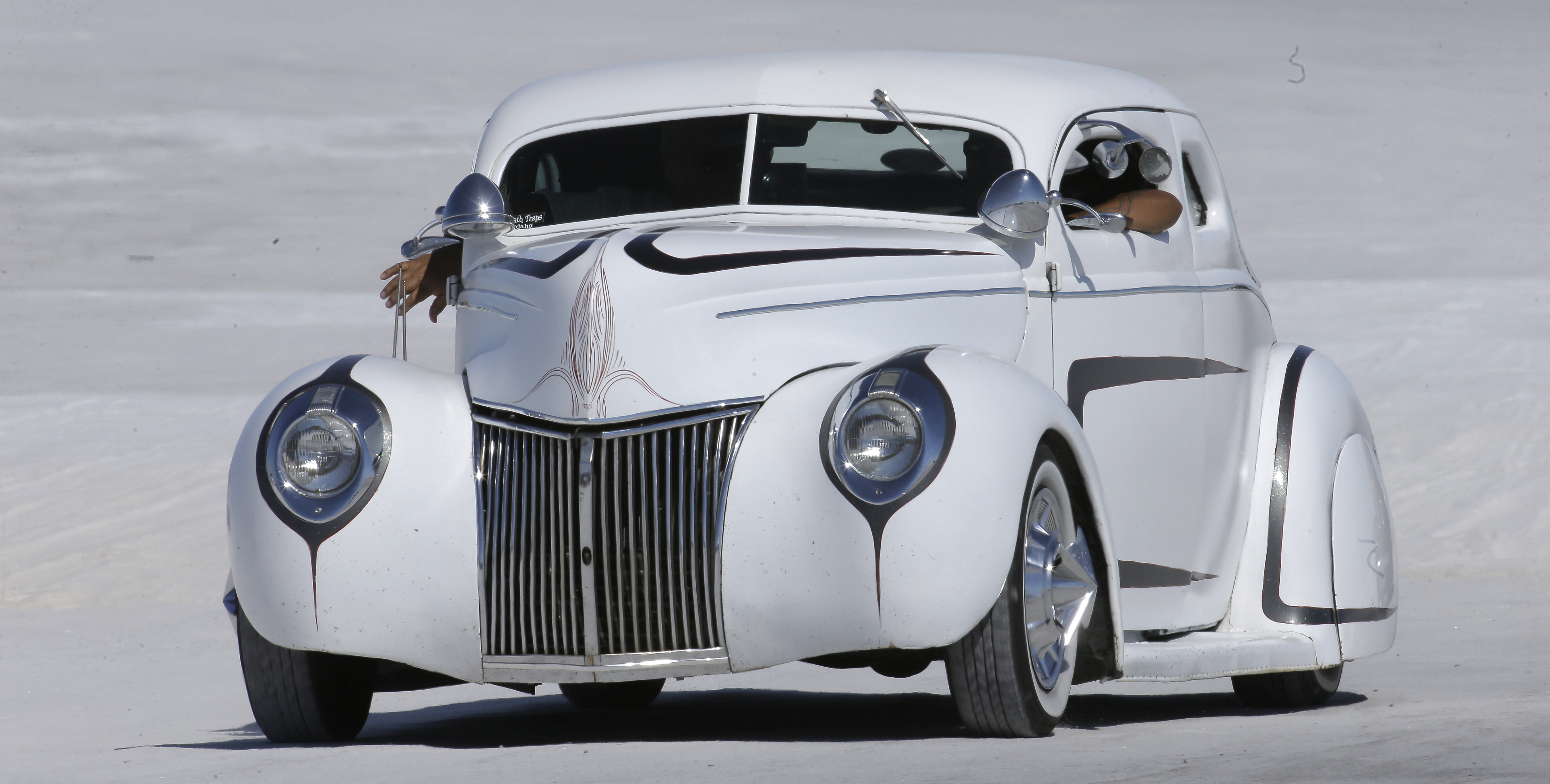 This Saturday, Aug. 13, 2016, photo, a car rides along the Bonneville Salt Flats, near Wendover, Utah. Speed-starved racers are finally back at Utah's world-famous Bonneville Salt Flats to hit speeds of 400 mph or more as they compete in Speed Week for the first time since 2013 after wet weather and rough salt cancelled the races for the last two years. (AP Photo/Rick Bowmer)