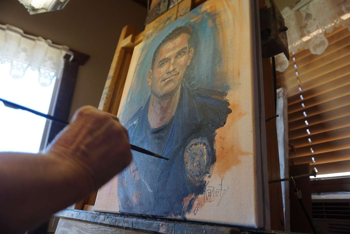 Kaziah Hancock, seen here in Manti on Thursday, Aug. 11, 2016, spends her days painting the faces of men and women in uniform she has never met, paying close attention to detail to help memorialize officers who died in the line of duty. She does her works of art free of charge. (Photo: Sam Penrod, Deseret News)