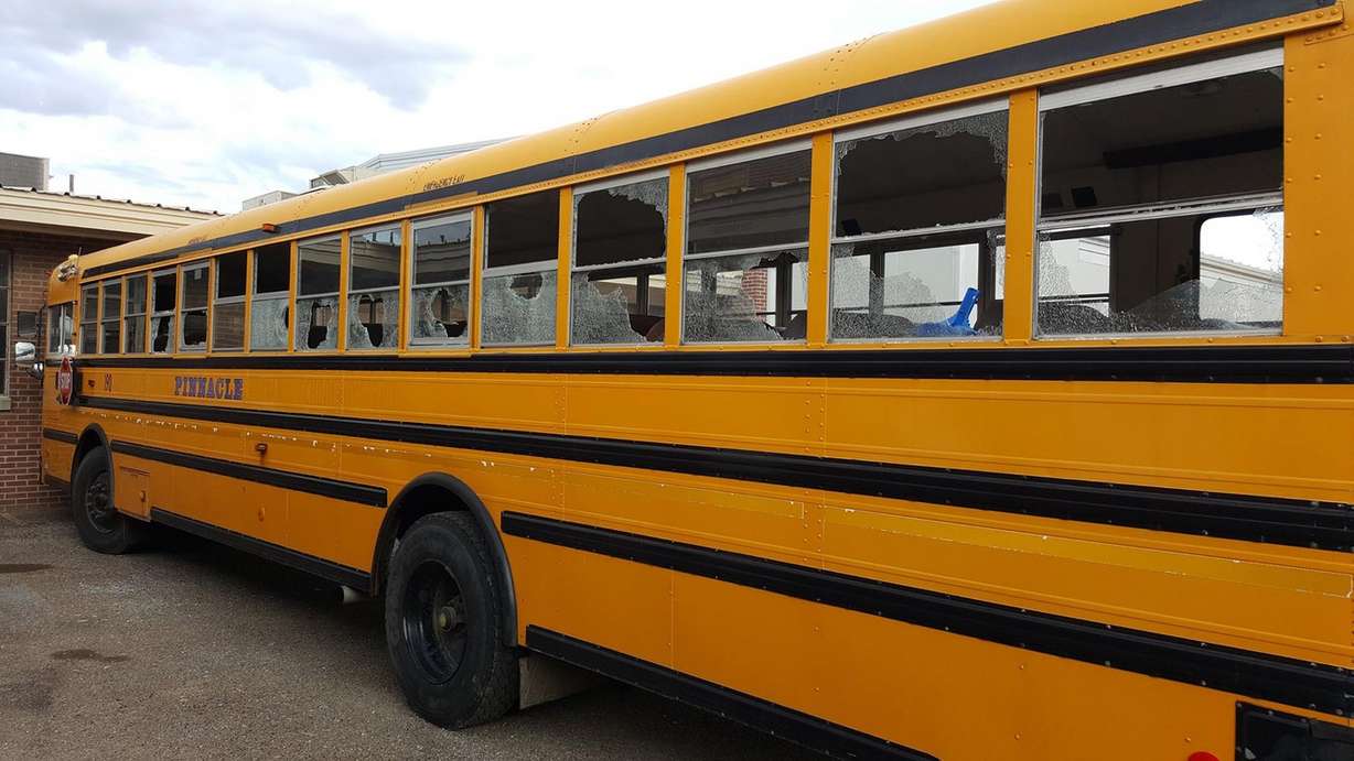 Vandals bust school bus windows, damage 60 vehicles
