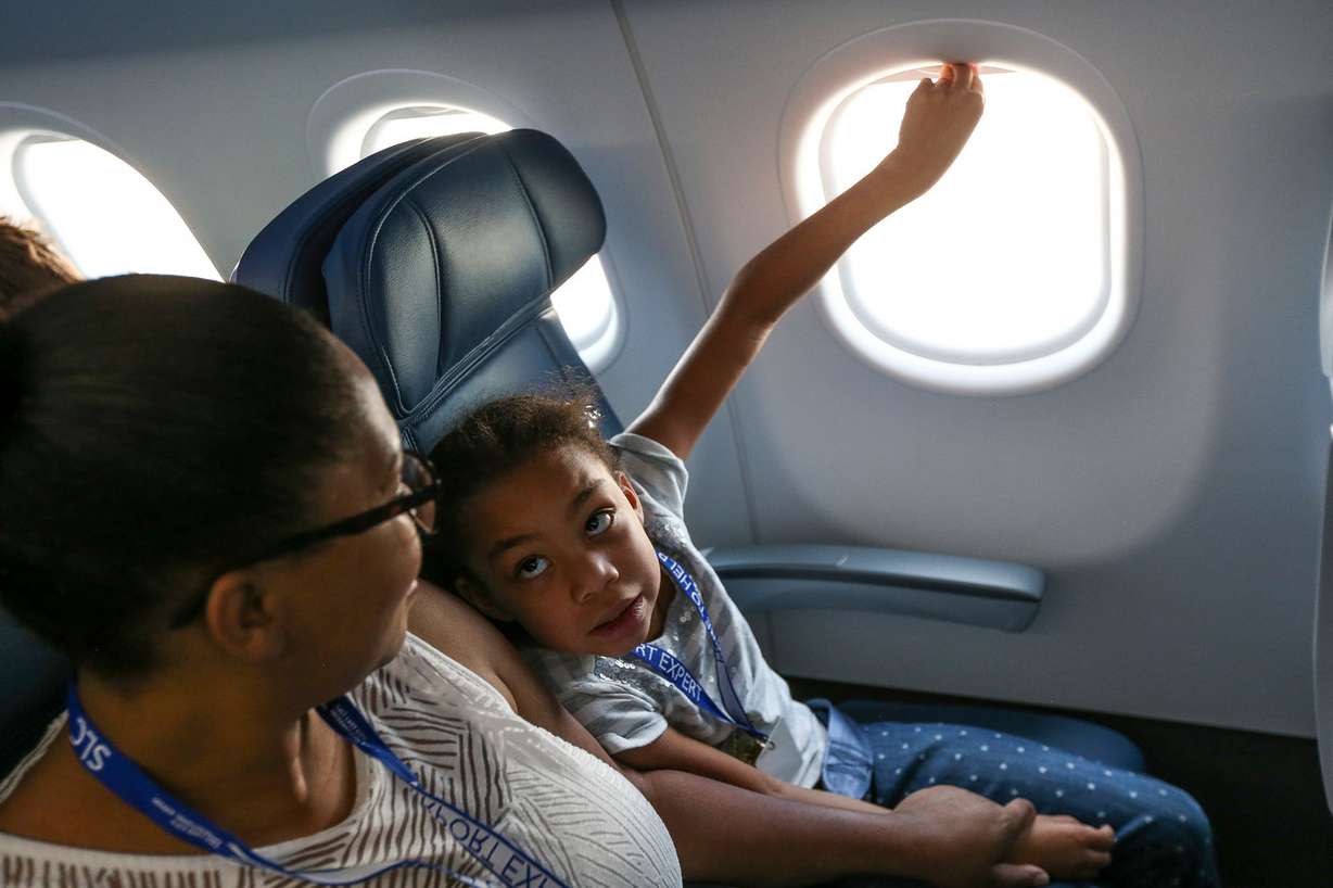Bianca Mittendorf, of Ogden, and her daughter, Maya Whiten, 7, take a mock flight at the Salt Lake City International Airport on Saturday, Aug. 20, 2016. Taking Flight for Autism is a program that allows autistic children and their families to get acquainted with the routines and sounds of air travel by staging a mock flight. (Photo: Spenser Heaps, Deseret News)