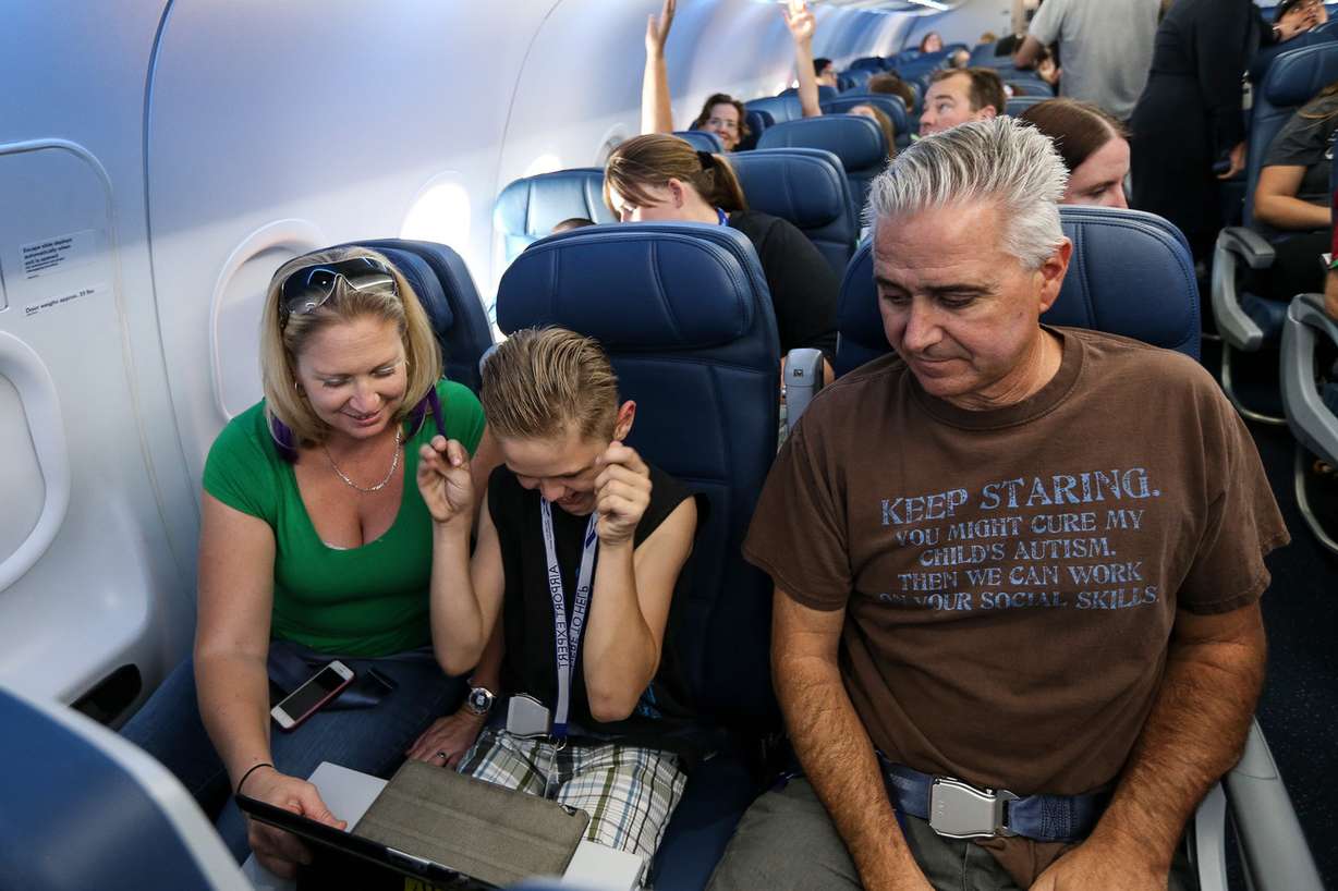 Diana and Shaun Bernardy, of Salt Lake City, and their son, Shaun Jr., 10, take a mock flight at the Salt Lake City International Airport on Saturday, Aug. 20, 2016. (Photo: Spenser Heaps, Deseret News)