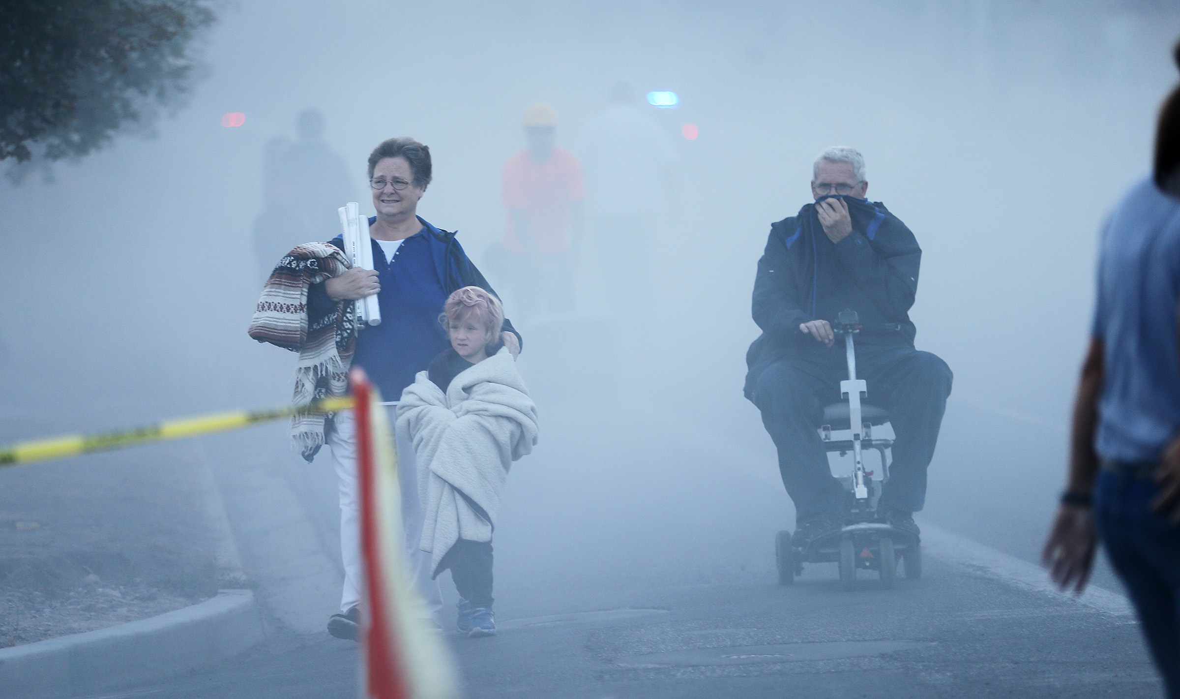 Provo residents make their way away from the cloud of dust after the 77-year-old Provo Power smokestacks were demolished on Sunday, Aug. 21, 2016. (Photo: Scott G. Winterton, Deseret News)