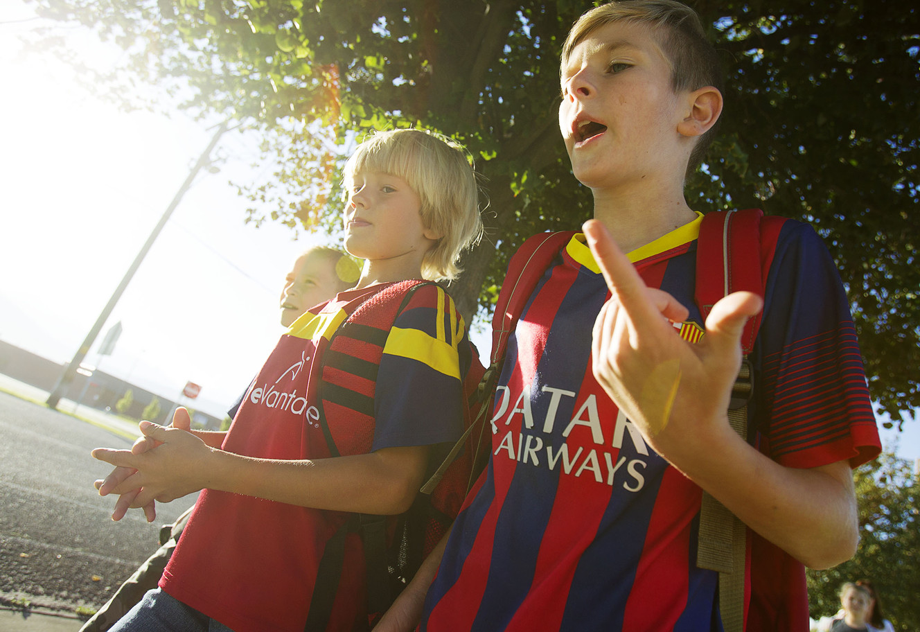 Derek Smith, right, talks to Heber MacPheren as they walk to Southland Elementary School in Riverton on Wednesday, Aug. 24, 2016. (Photo: Hans Koepsell, Deseret News)
