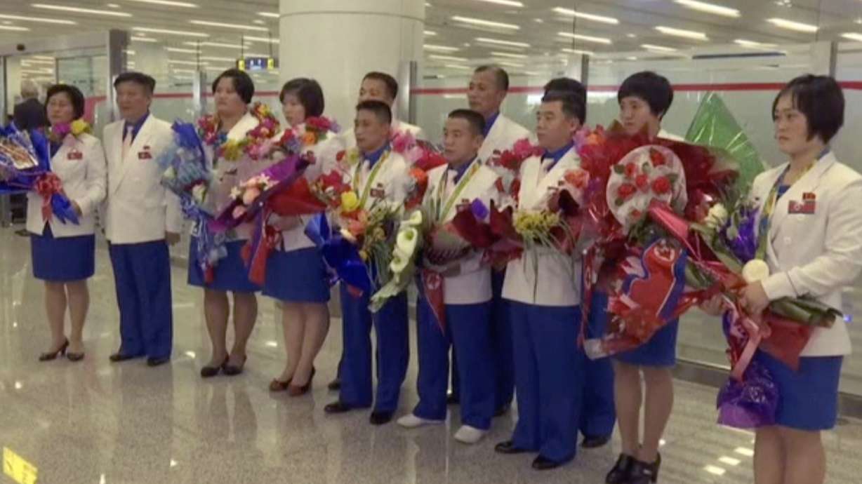North Korean Olympic athletes return to low-key welcome home