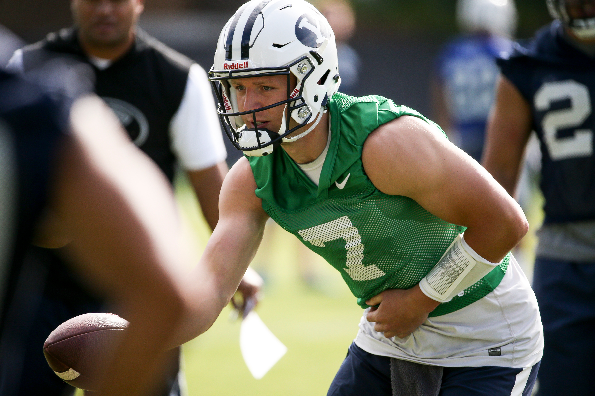 Quarterback Taysom Hill hands the ball off during a drill on the opening day of Brigham Young University football fall camp at the school's outdoor practice field in Provo on Friday, Aug. 5, 2016. (Photo: Spenser Heaps, Deseret News)