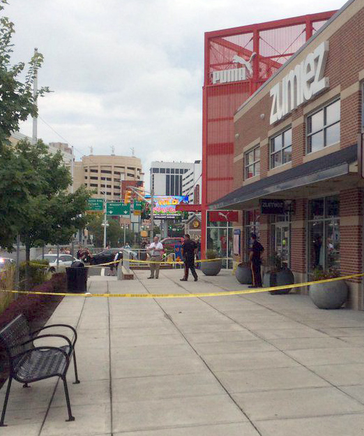 The Latest: Officials ID victim, suspect in outlet shooting