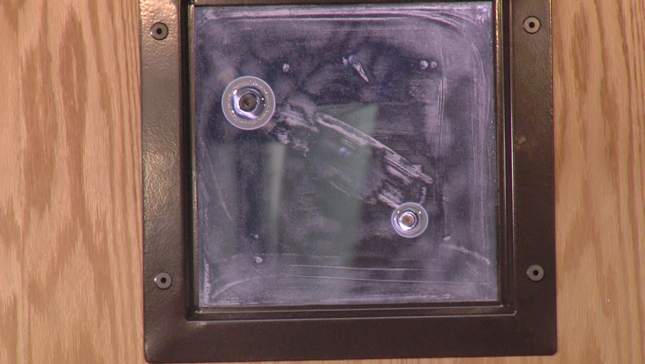 LifeSafe armored door shot with two different handguns. The bullets remained embedded in the glass window. (Photo: Mike Radice, KSL TV)