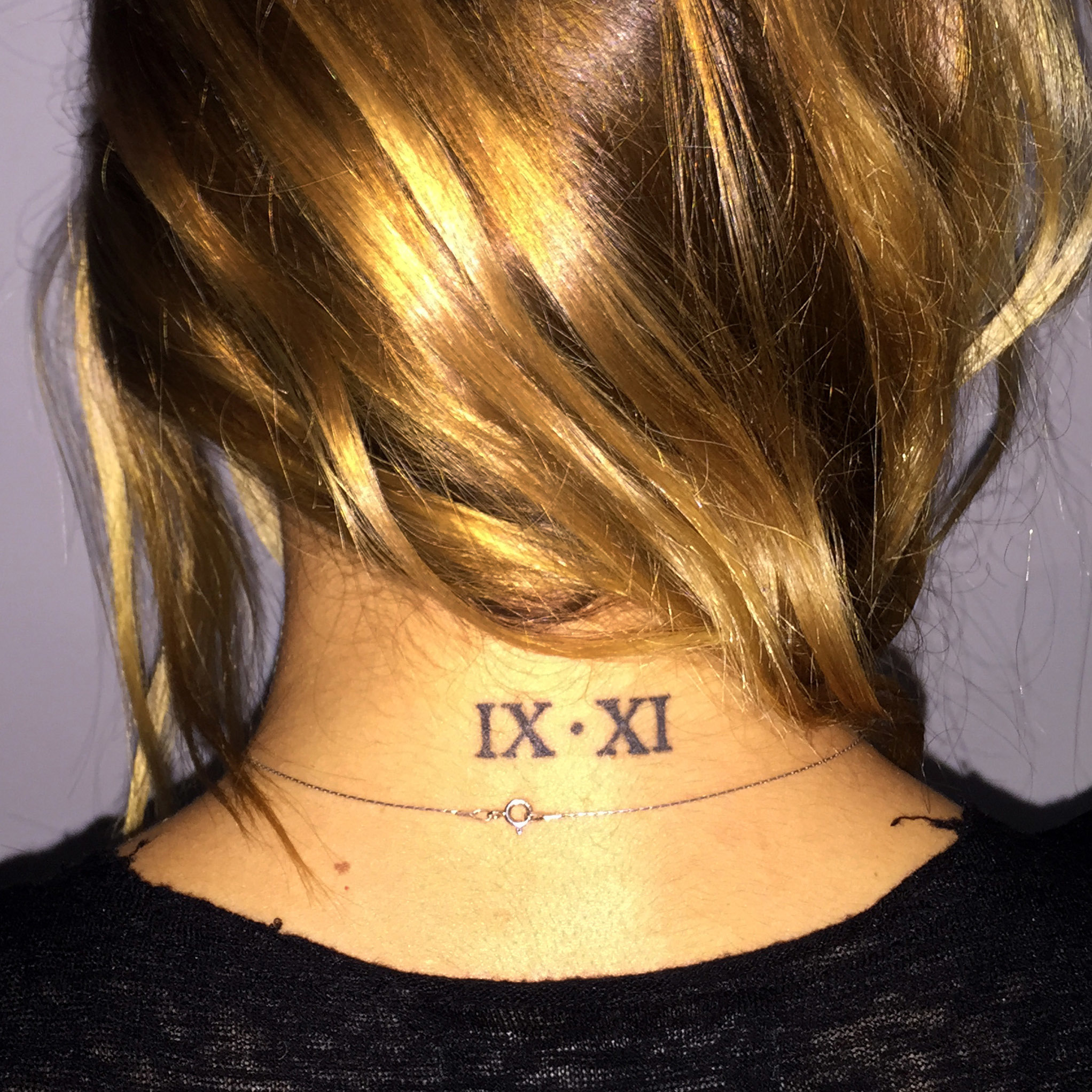 This photo provided by Ryan McGowan shows her tattoo with 9/11 in Roman numerals on the back of her neck in Boston on Thursday Sept. 1, 2016. Photo: AP Photo