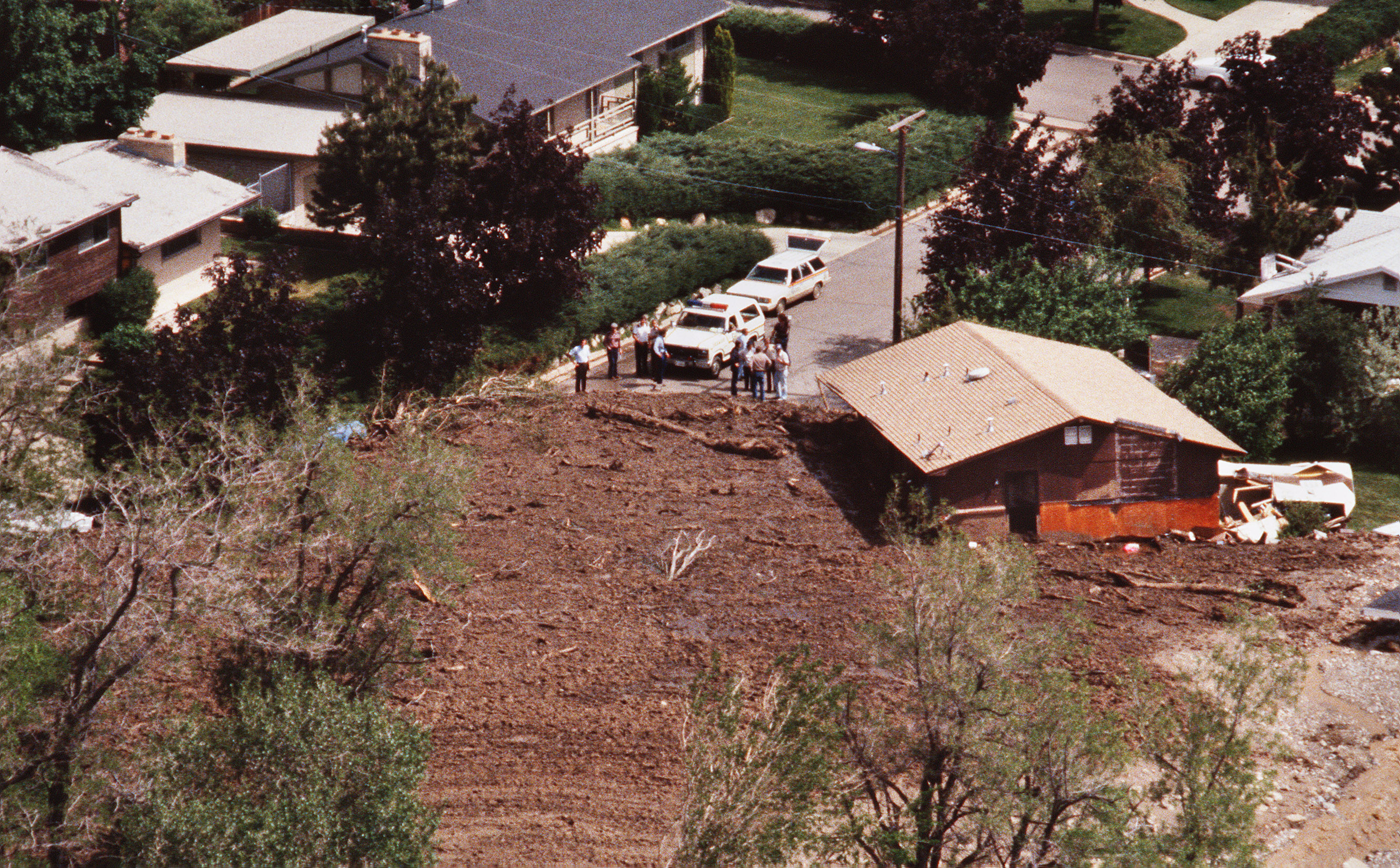 The home of Don and Karen Sims, at right, was moved off its foundation and pushed along in the mudslide in Farmington in 1983. (Photo: Ravell Call)