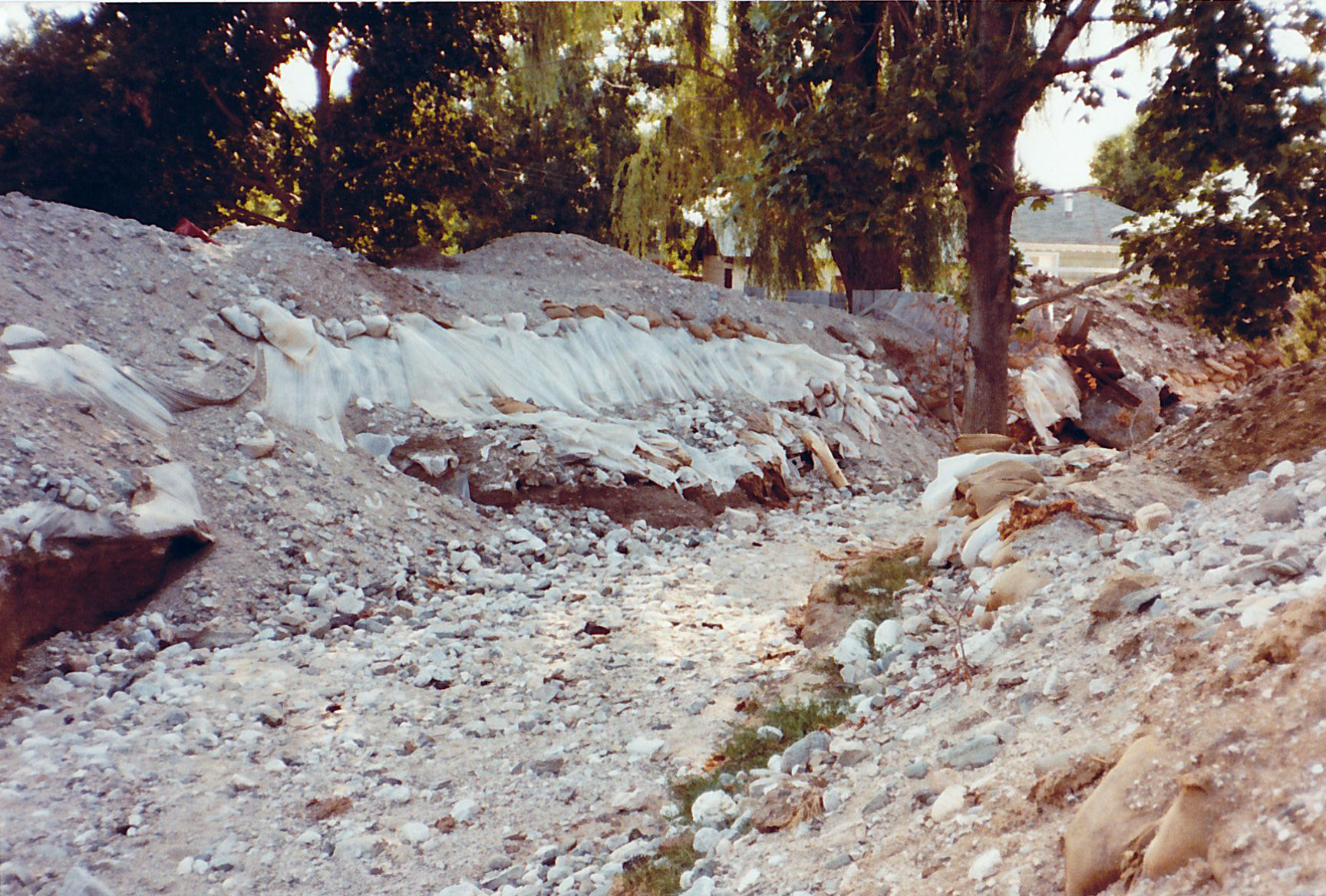 The aftermath of the flood of 1983 in Bountiful, Utah. Plastic and sandbags line a dry creek bed. (Photo: Orland Call)