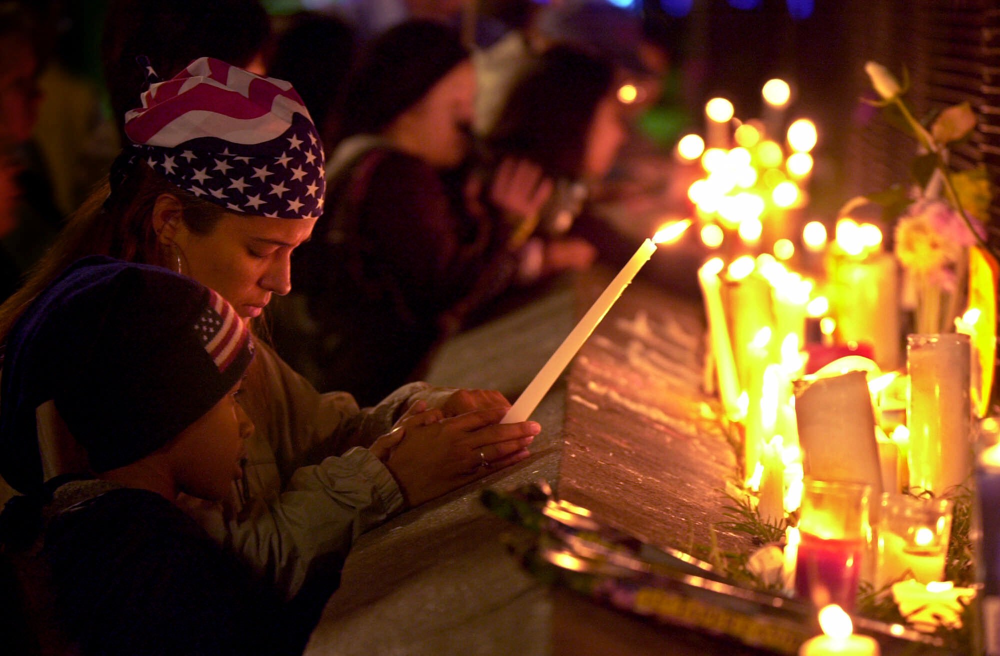 Annabelle Banievicz, and her son, Oriel Vanega, 7, attend a candlelight vigil Friday, Sept. 14, 2001, at Union Square in New York, not far from the site of Tuesday's terrorist attack against the World Trade Center. (Mark Lennihan, AP Photo)