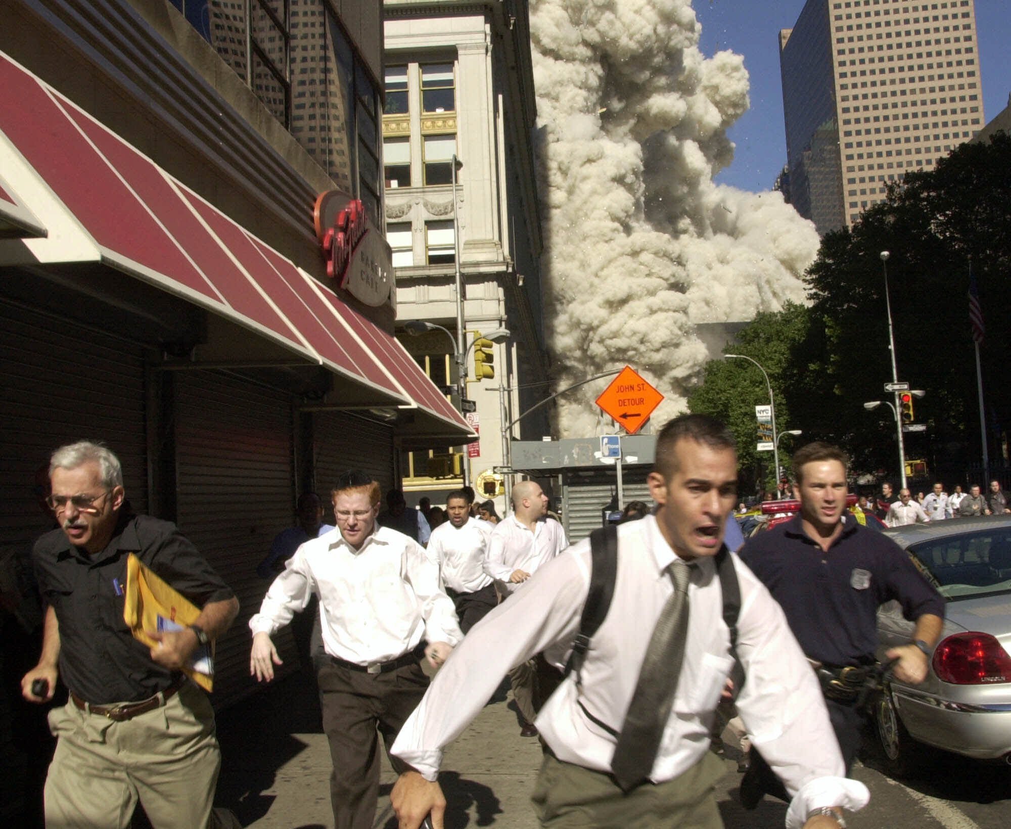 People run from the collapse of World Trade Center Tower Tuesday, Sept. 11, 2001 in New York. (Suzanne Plunkett, AP Photo)