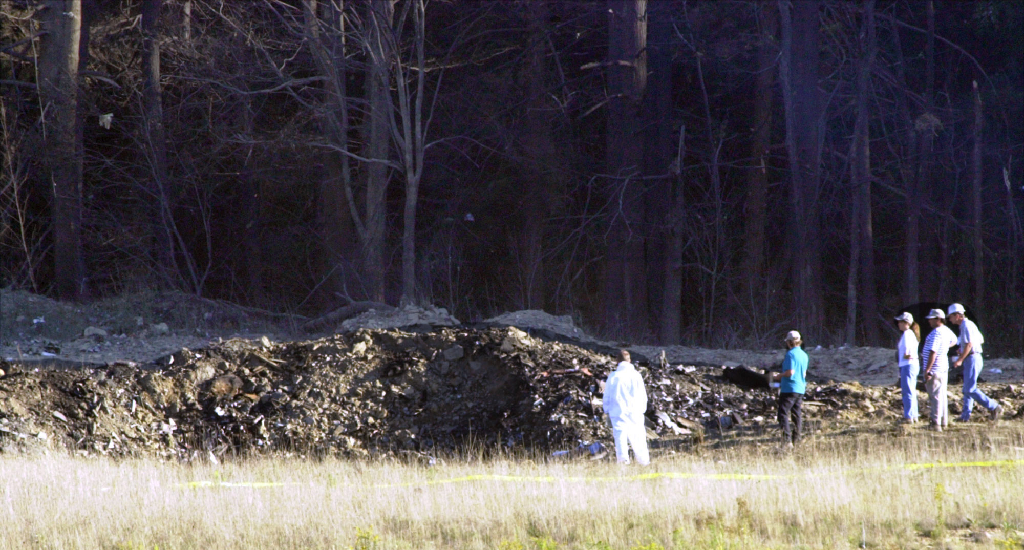 Emergency workers look at the crater created when United Airlines Flight 93 crashed near Shanksville, Pa., on Tuesday, Sept. 11, 2001. (Keith Srakocic, AP Photo)