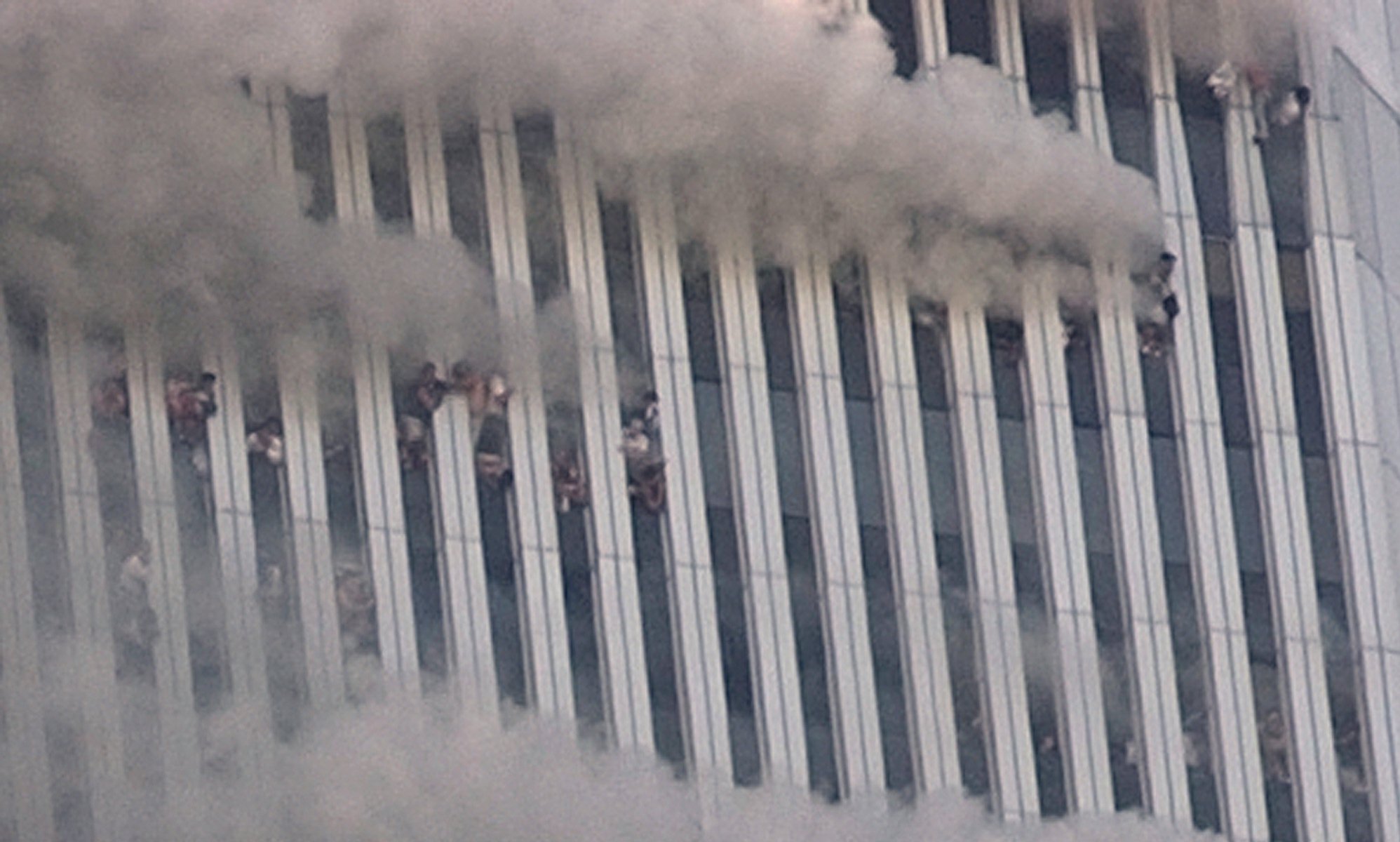 People hang out of broken windows of the North Tower of the World Trade Center after a terrorist attack in New York on the morning of Sept. 11, 2001. (Amy Sancetta, AP Photo)