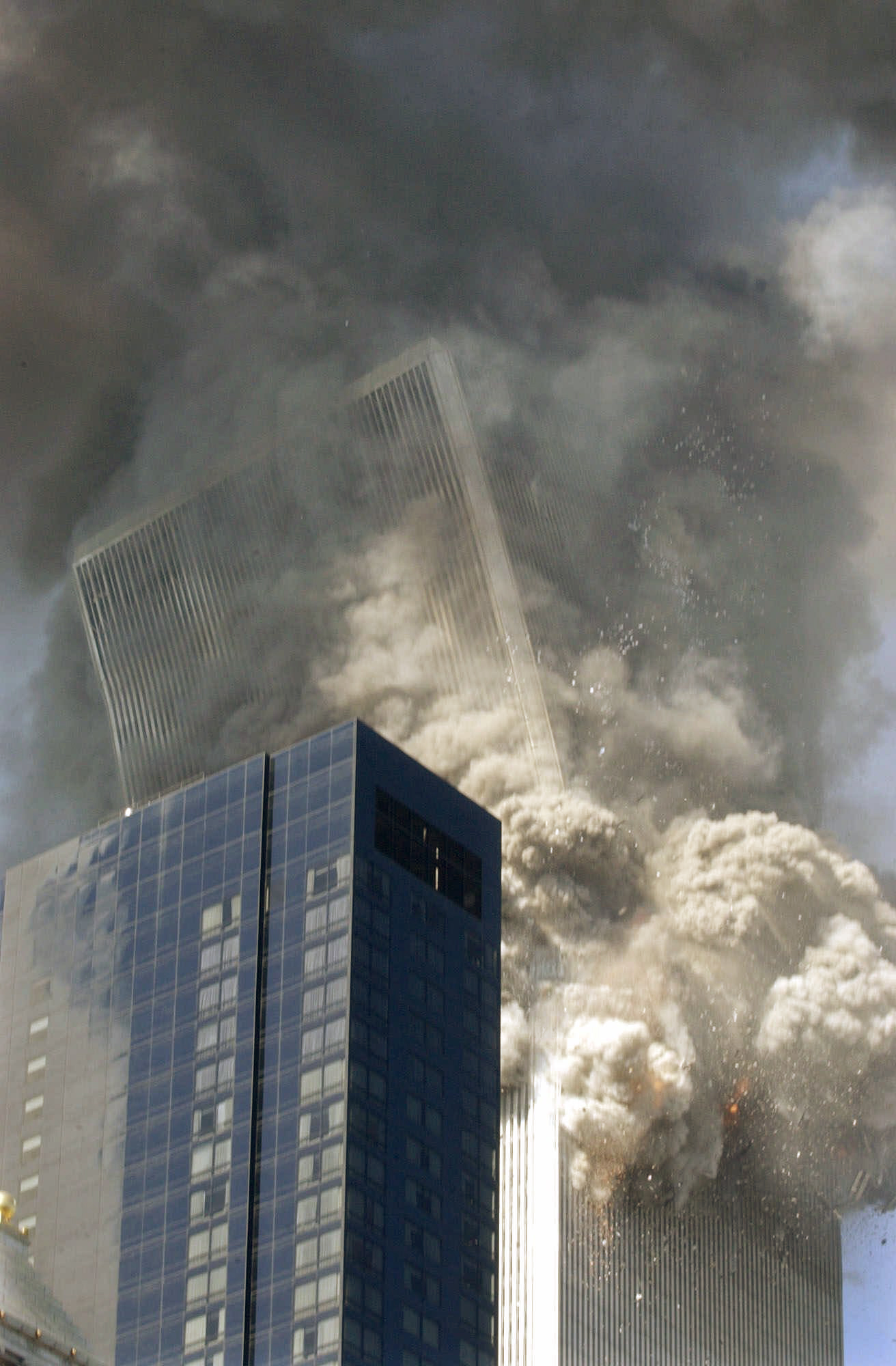 The south tower of the World Trade Center begins to collapse following the terrorist attack on the New York landmark Tuesday, Sept. 11, 2001. The Millenium Hilton hotel is in foreground. (Amy Sancetta, AP Photo)