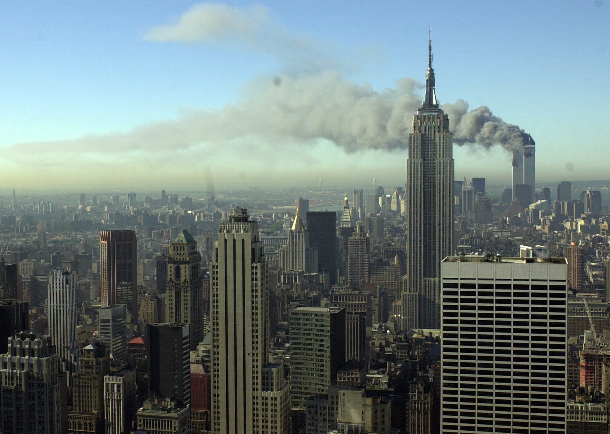 Plumes of smoke pour from the World Trade Center buildings in New York Tuesday, Sept. 11, 2001. (Patrick Sison, AP Photo)