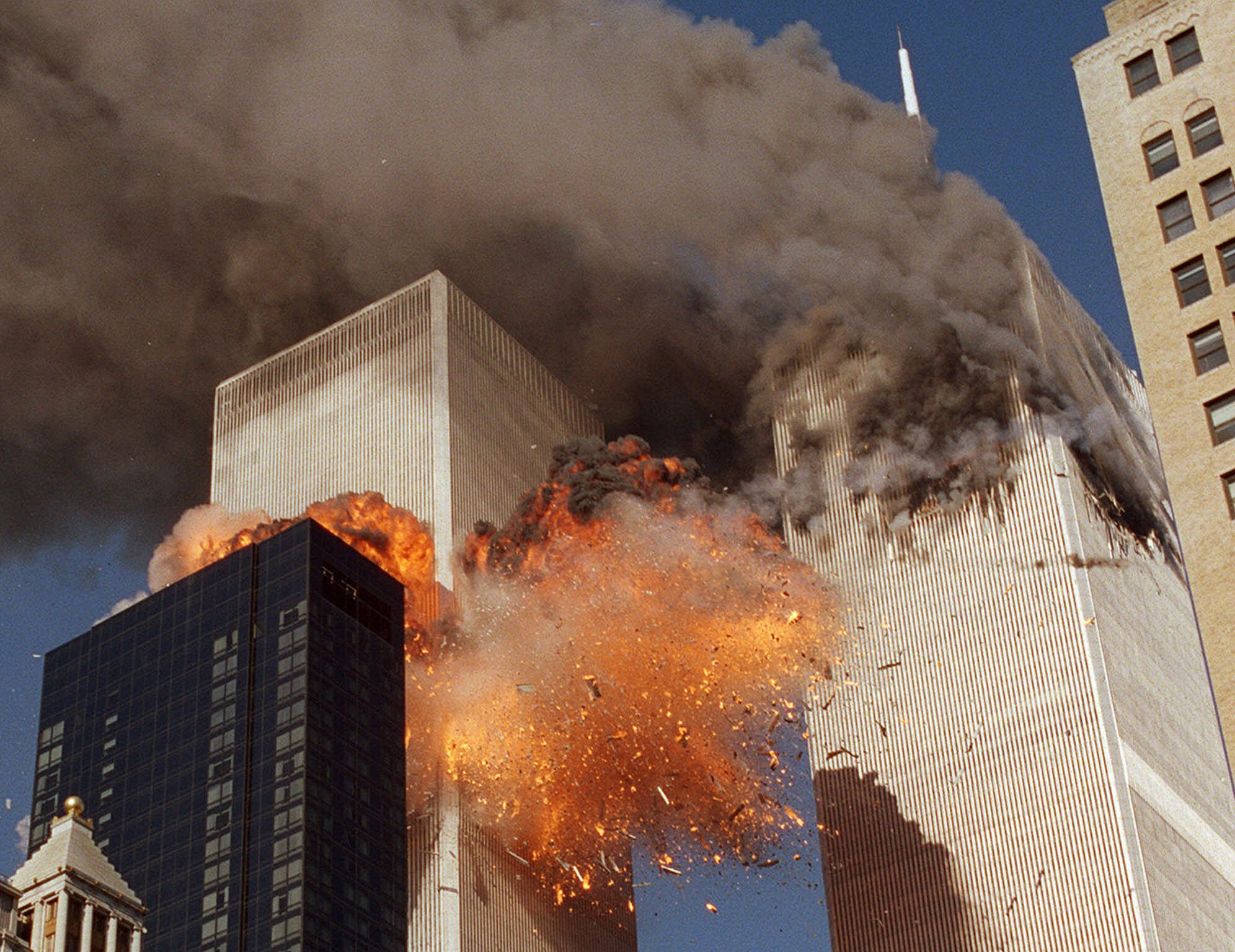 Smoke billows from one of the towers of the World Trade Center and flames as debris explodes from the second tower, in this Sept. 11, 2001, file photo. (Chao Soi Cheong, AP Photo)
