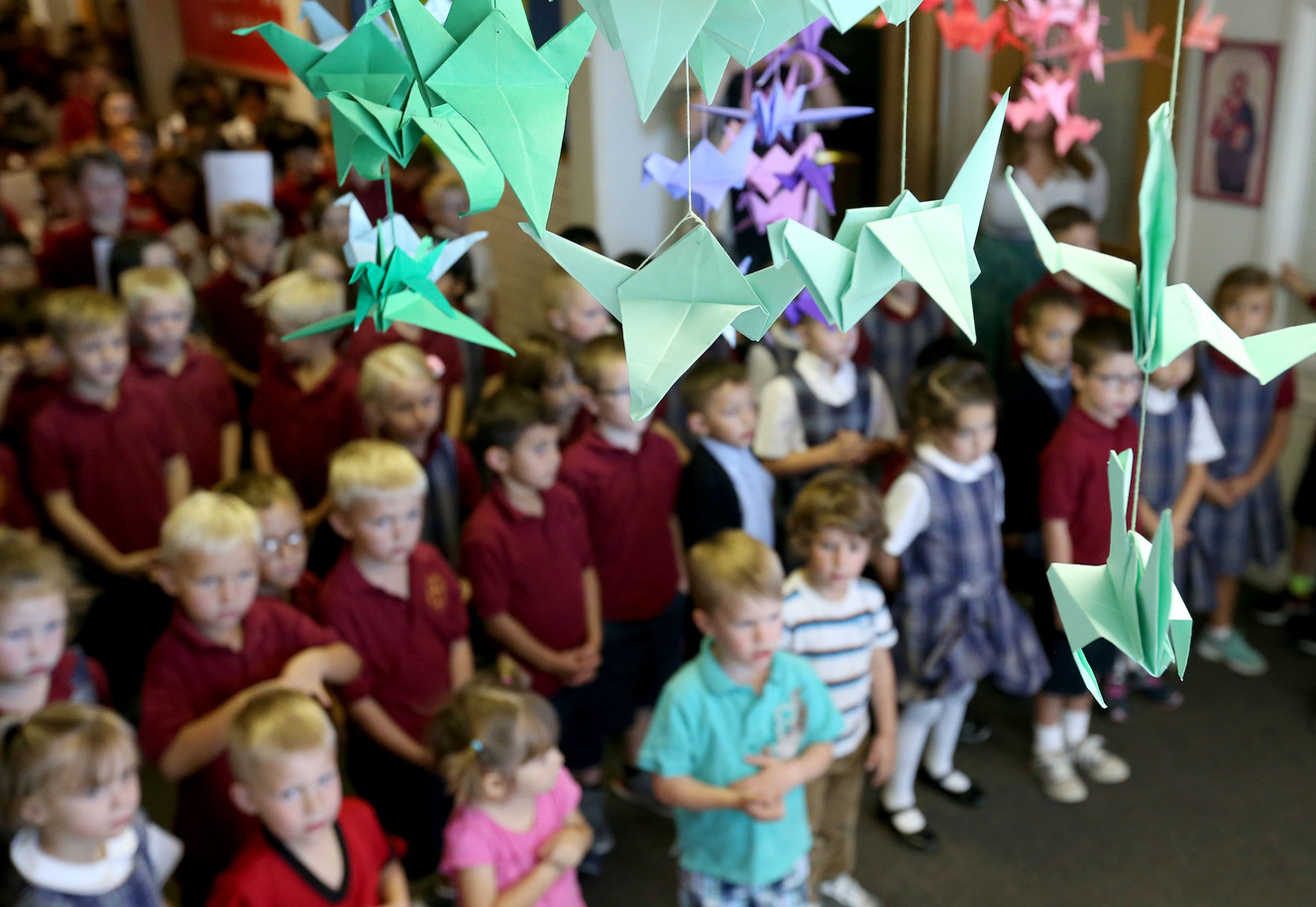St. Olaf Catholic School students gather underneath paper cranes and butterflies while participating in the Catholic Diocese of Salt Lake City’s observance of the National Day of Prayer for Peace in Our Communities in Bountiful on Friday, Sept. 9, 2016. (Photo: Laura Seitz, Deseret News)