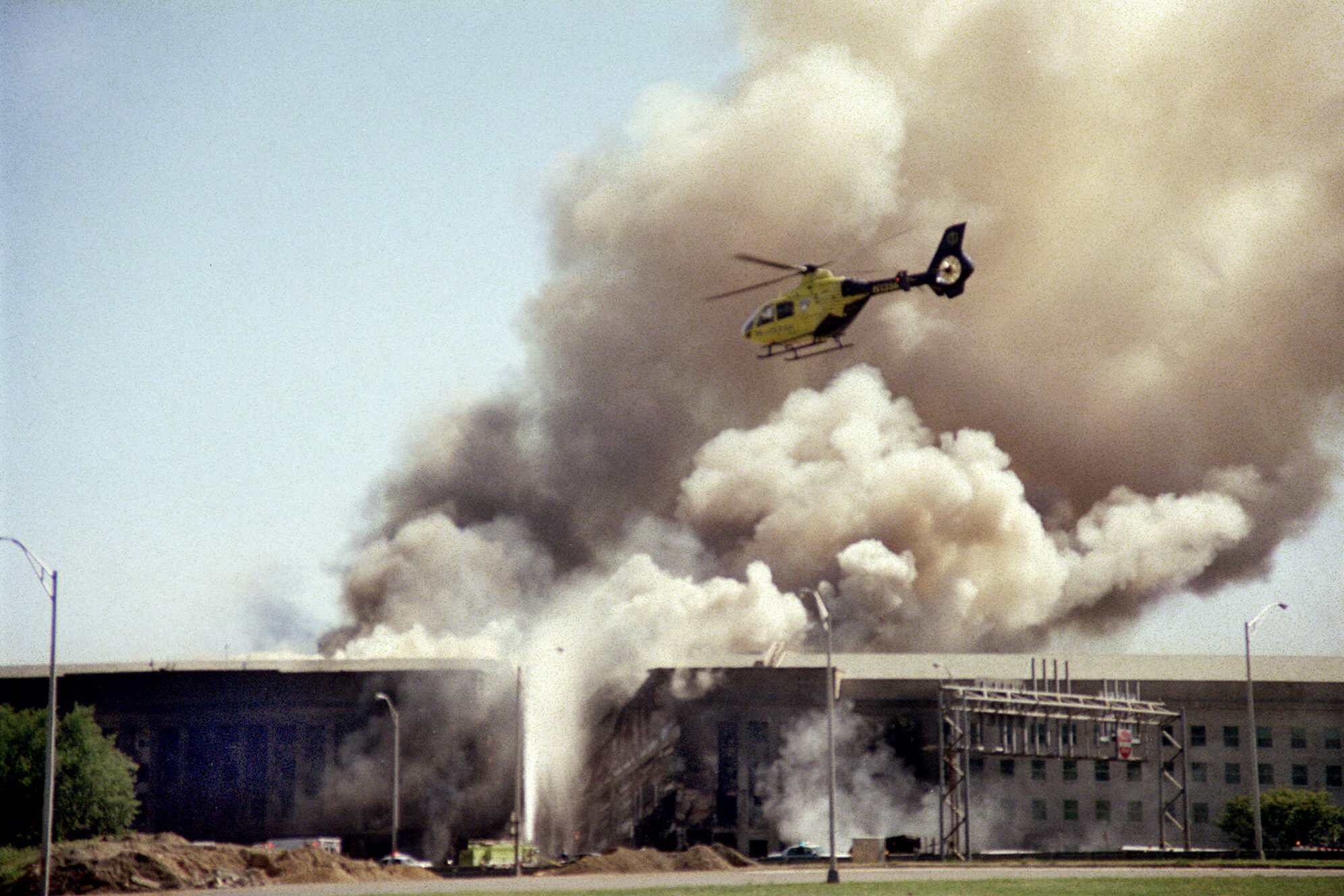 A helicopter flies over the Pentagon in Washington, Tuesday, Sept. 11, 2001 as smoke billows over the building. American Airlines Flight 77 crashed into the Pentagon at 9:37 a.m. (Heesoon Yim, AP Photo)