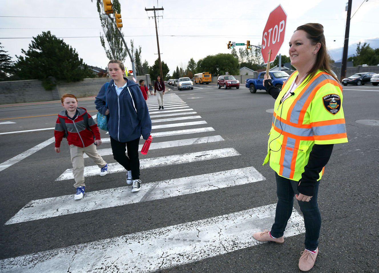 Crossing guard Trudy Smith helps students cross the street near Hawthorn Academy and Westvale Elementary School in West Jordan on Wednesday, Sept. 14, 2016. (Photo: Kristin Murphy, Deseret News)