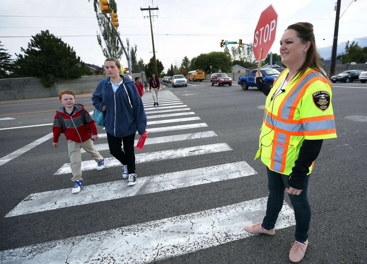 Crossing guard Trudy Smith helps students cross the street near Hawthorn Academy and Westvale Elementary School in West Jordan on Wednesday, Sept. 14, 2016. (Photo: Kristin Murphy, Deseret News)