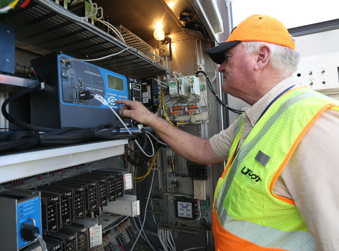 Roy Gregerson, Utah Department of Transportation electronics manager, adds three seconds to a crosswalk signal near Hawthorn Academy and Westvale Elementary School in West Jordan on Wednesday, Sept. 14, 2016. Crossing guards can now temporarily add extra walk time on a crosswalk signal during peak periods to increase safety. (Photo: Kristin Murphy, Deseret News)
